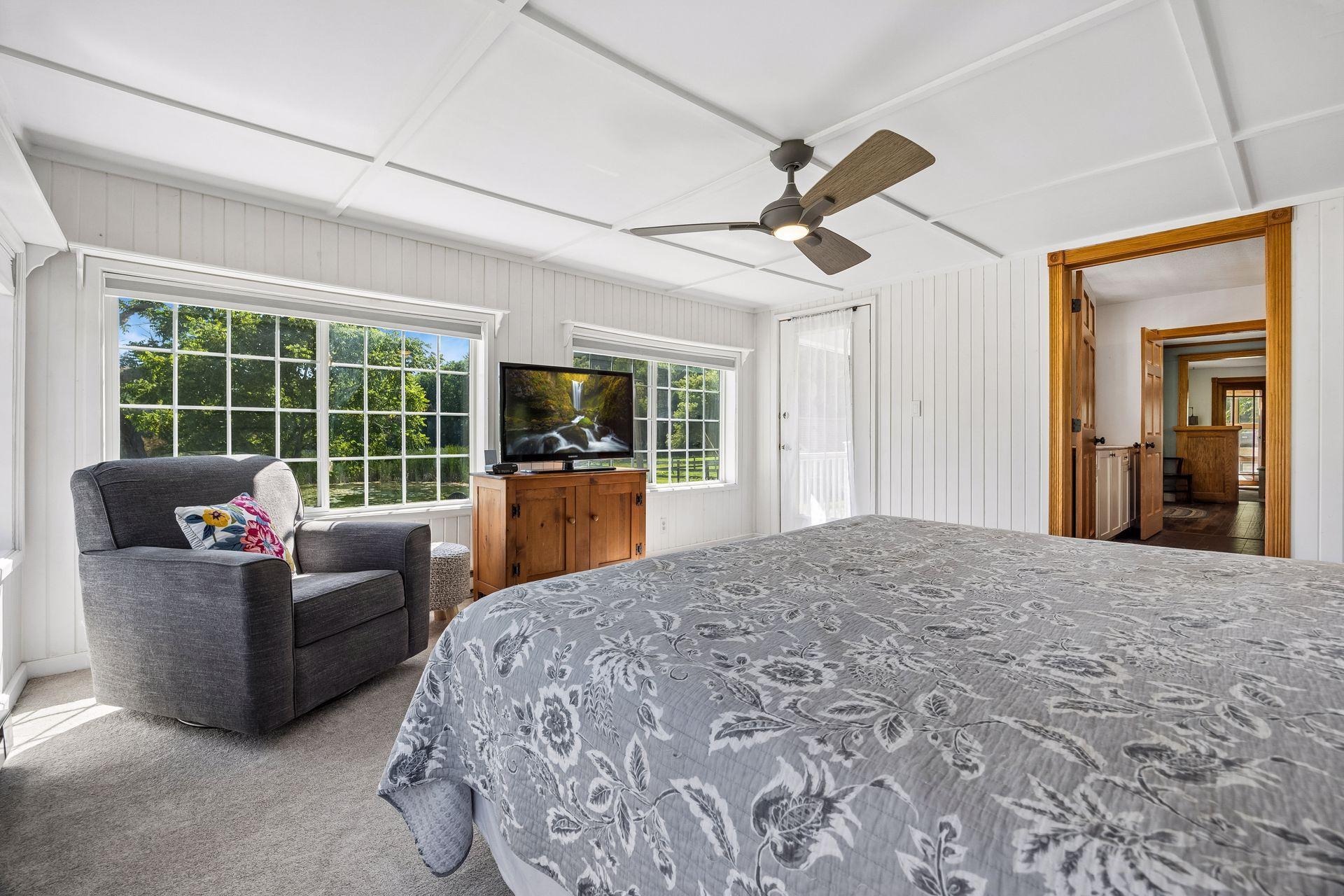 Main level primary bedroom also has a door that leads to the front porch