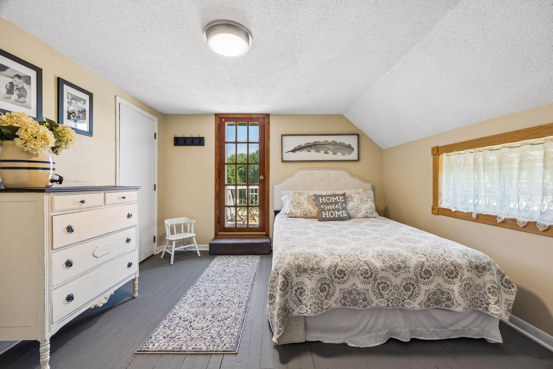 The 3rd upper level bedroom has the original wood floors, and leads to a private balcony!