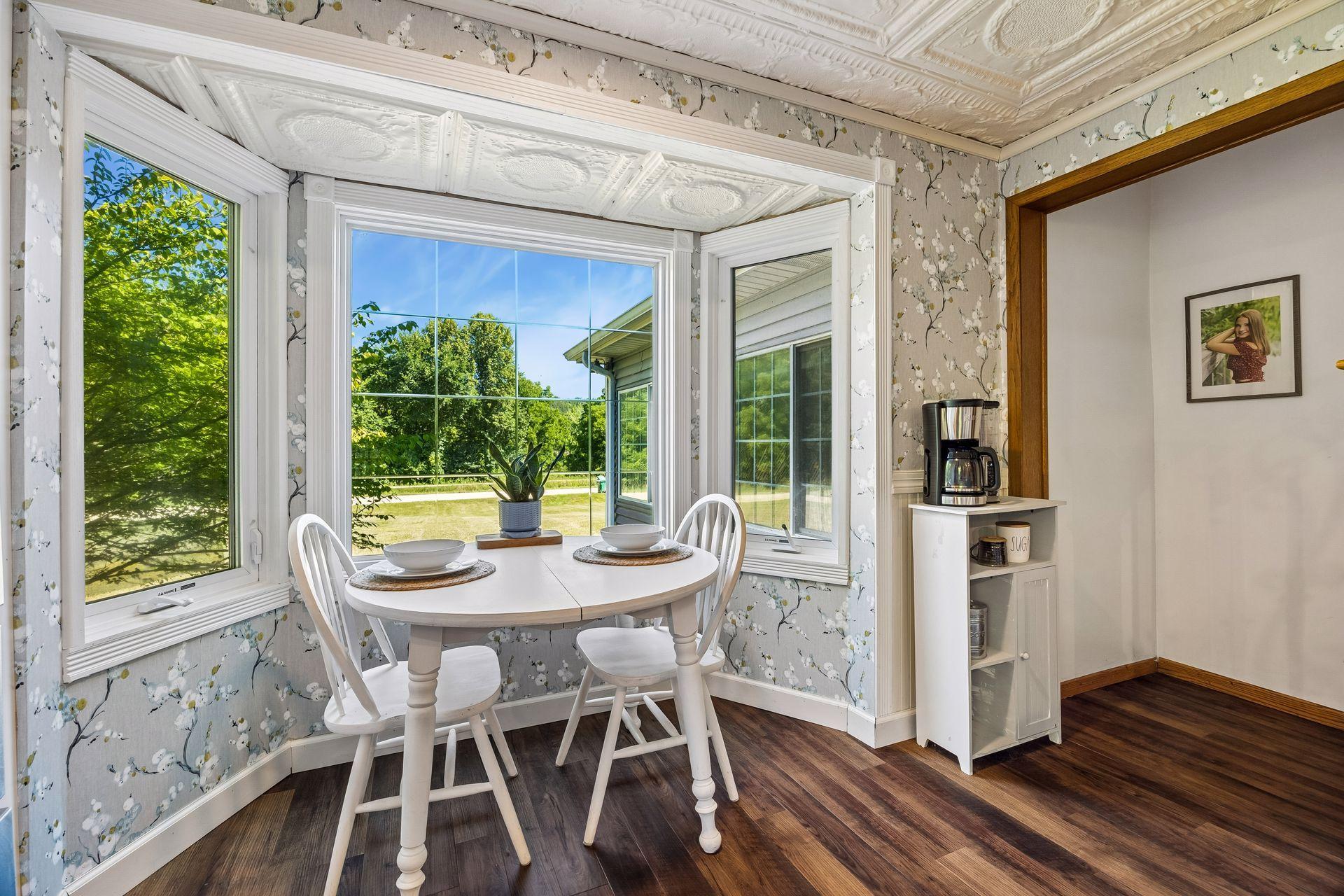 An eat-in kitchen has a cozy feel and a beautiful view!