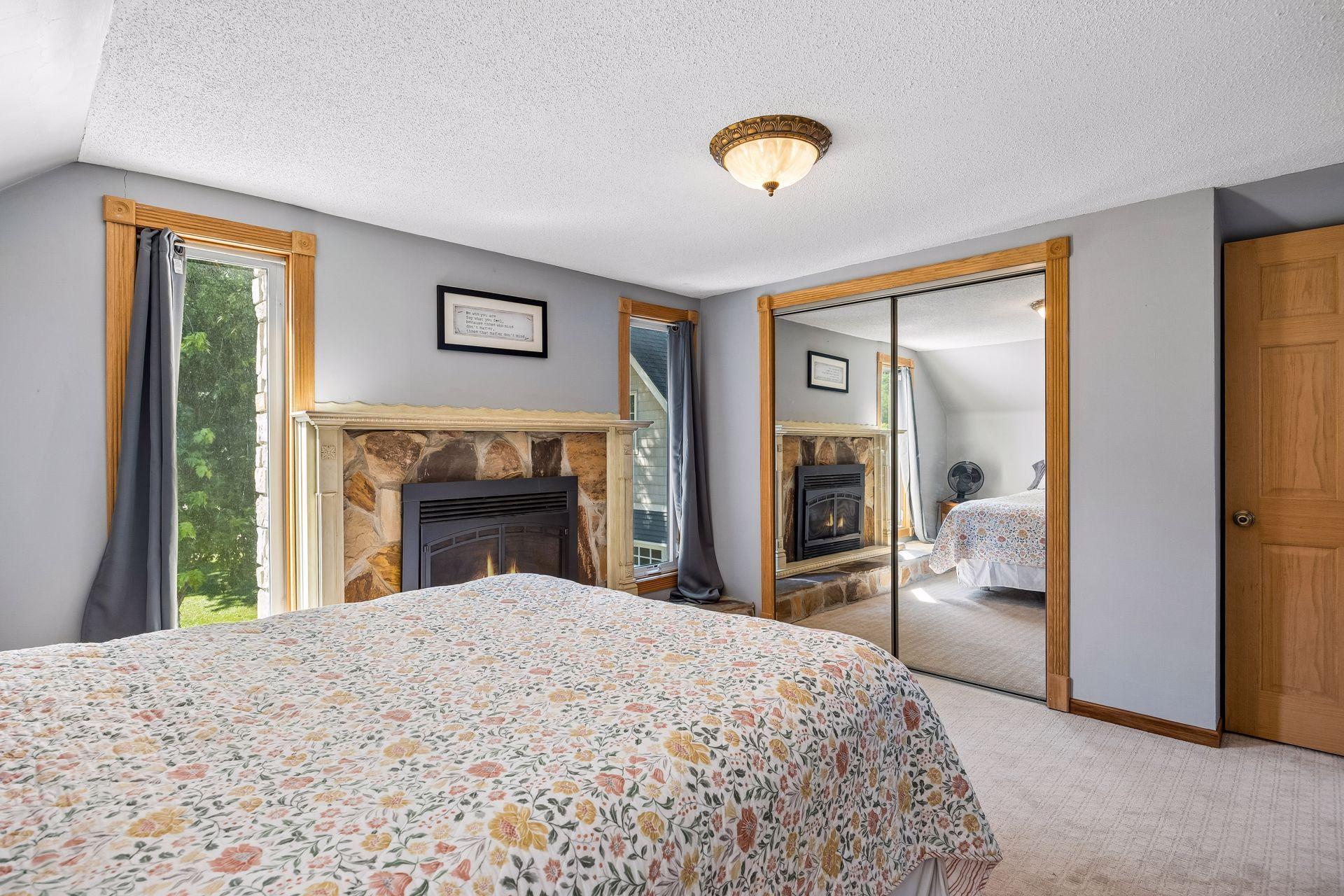 Previously the primary bedroom, it's got a cozy gas fireplace and floor-to-ceiling windows