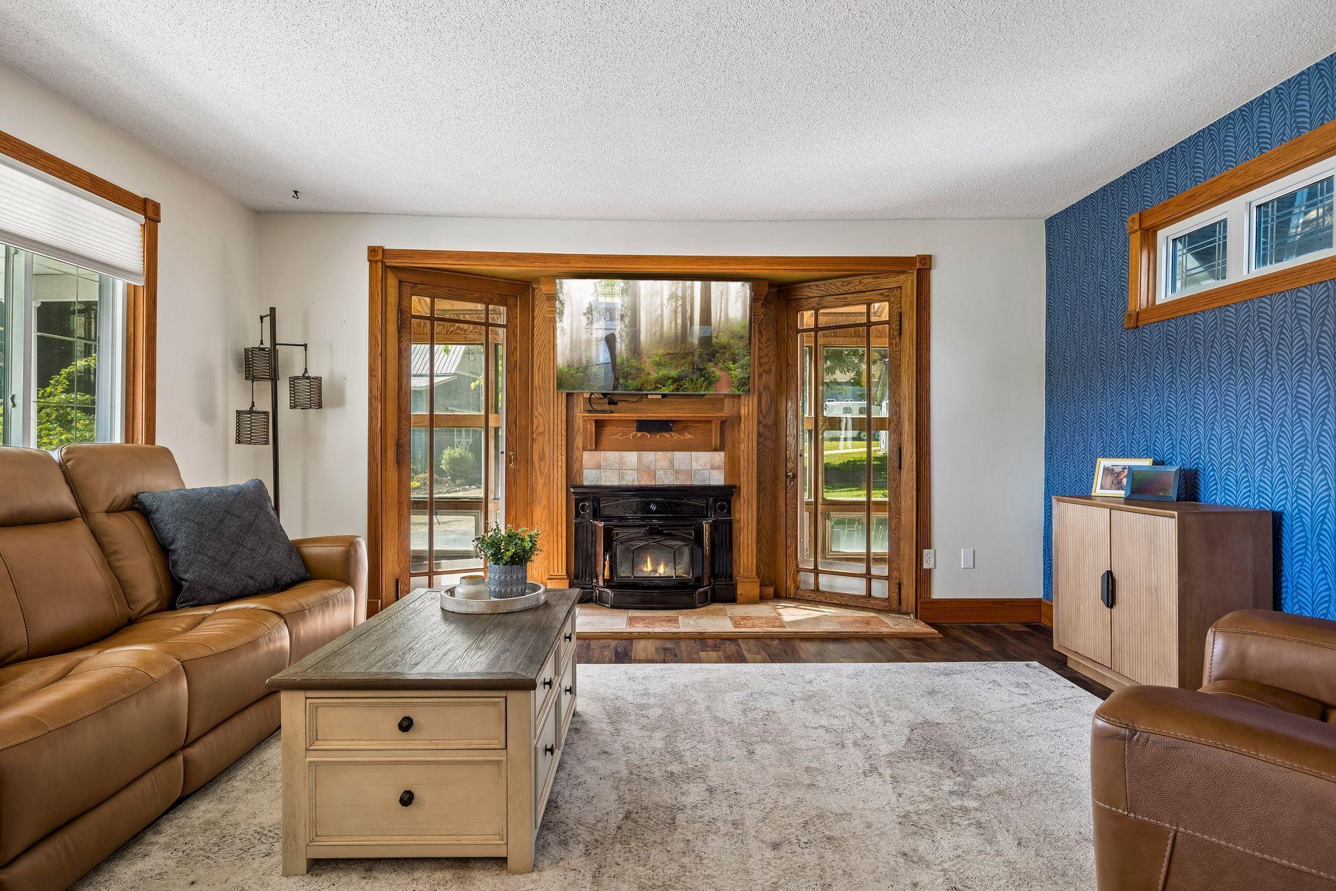 The focal point of the living room is the wood-burning fireplace. The windows and the 3-season porch beyond provide so much natural light.