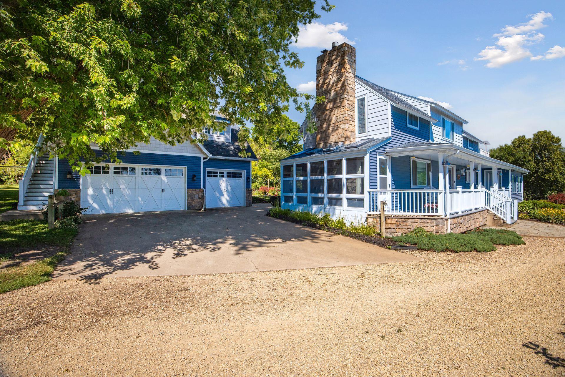 Detached 3-car garage and the 3-season porch are seen here