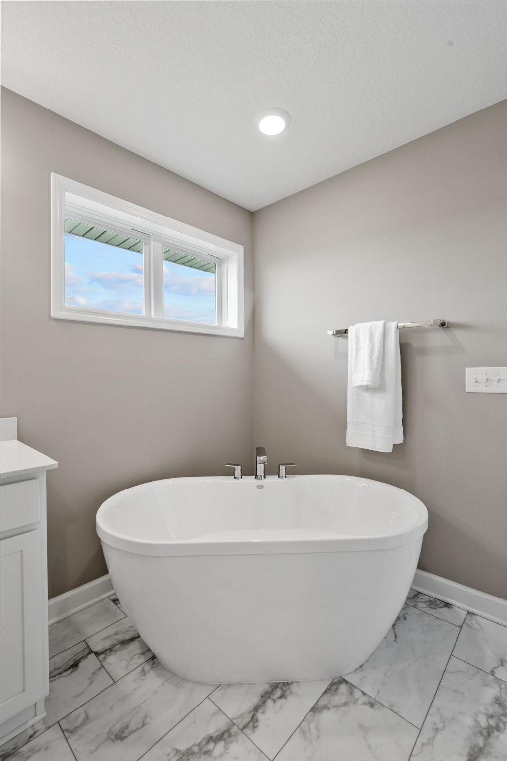 Features oversized soaker tub