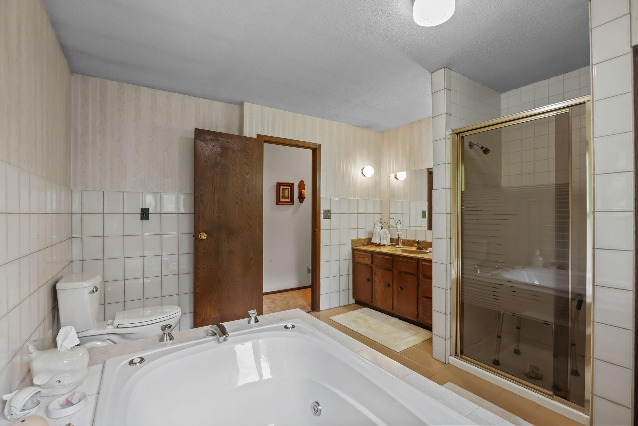 Spacious upstairs full bath with walk-in shower and jacuzzi tub.