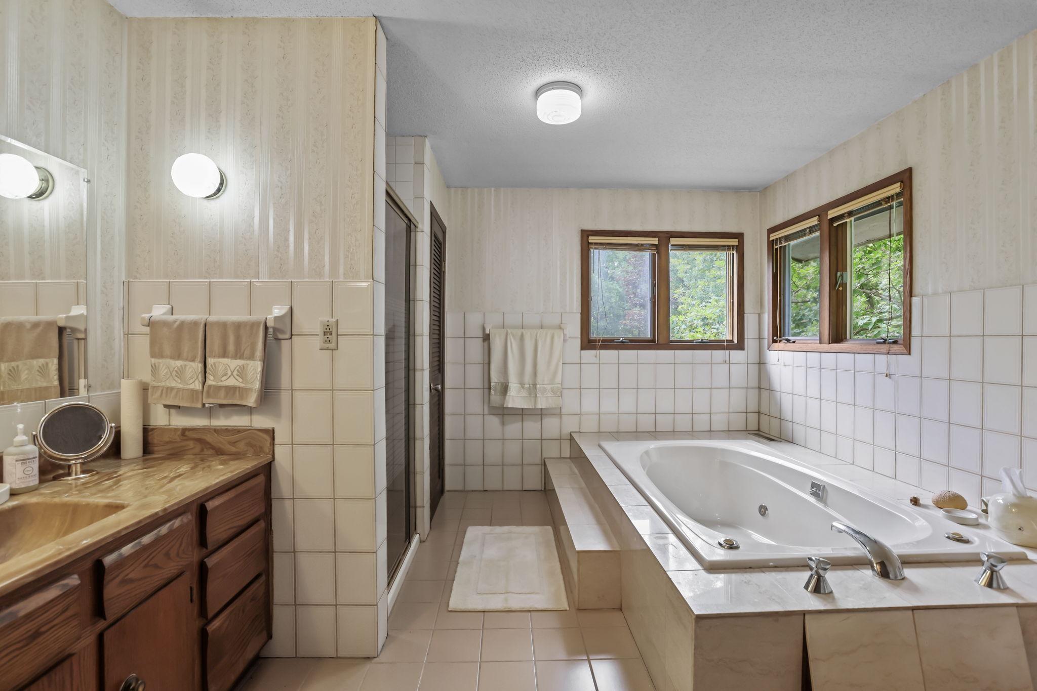 Spacious upstairs full bath with walk-in shower and jacuzzi tub.