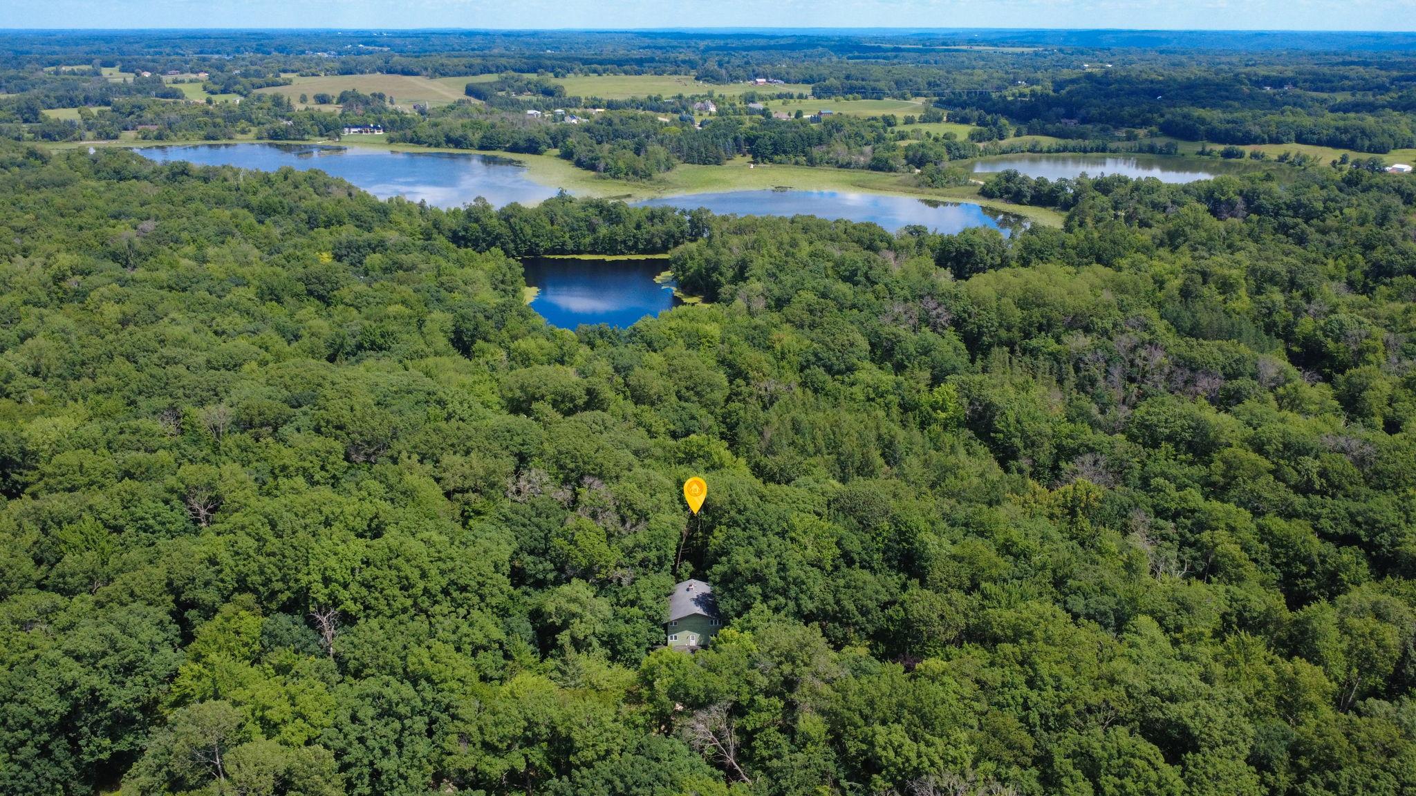 The home is nestled in a wooded area.