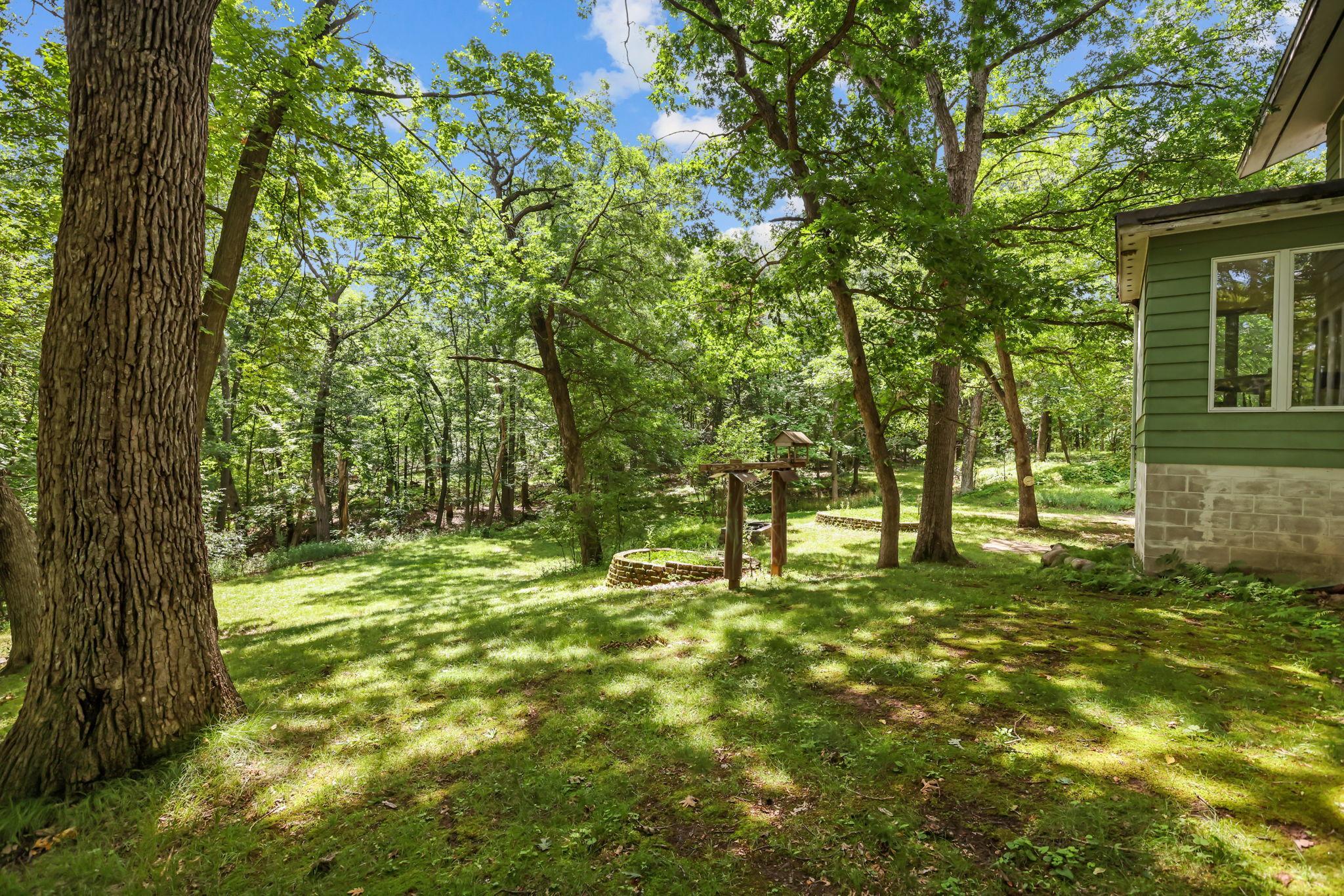 Serene, pleasant wooded grounds surround the home.
