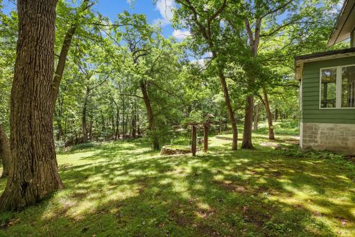 Serene, pleasant wooded grounds surround the home.