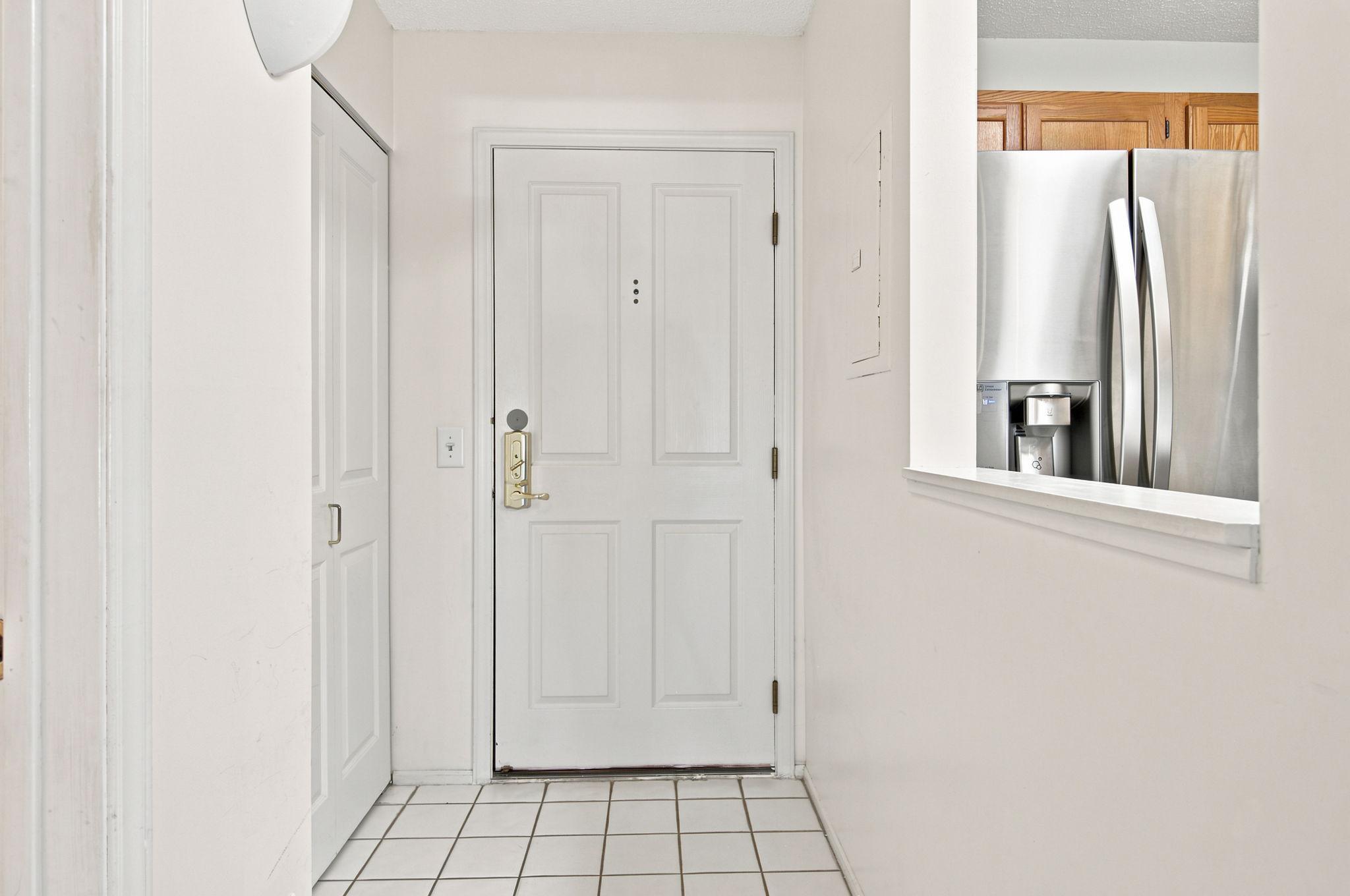 Coat closet and tile floor in entry