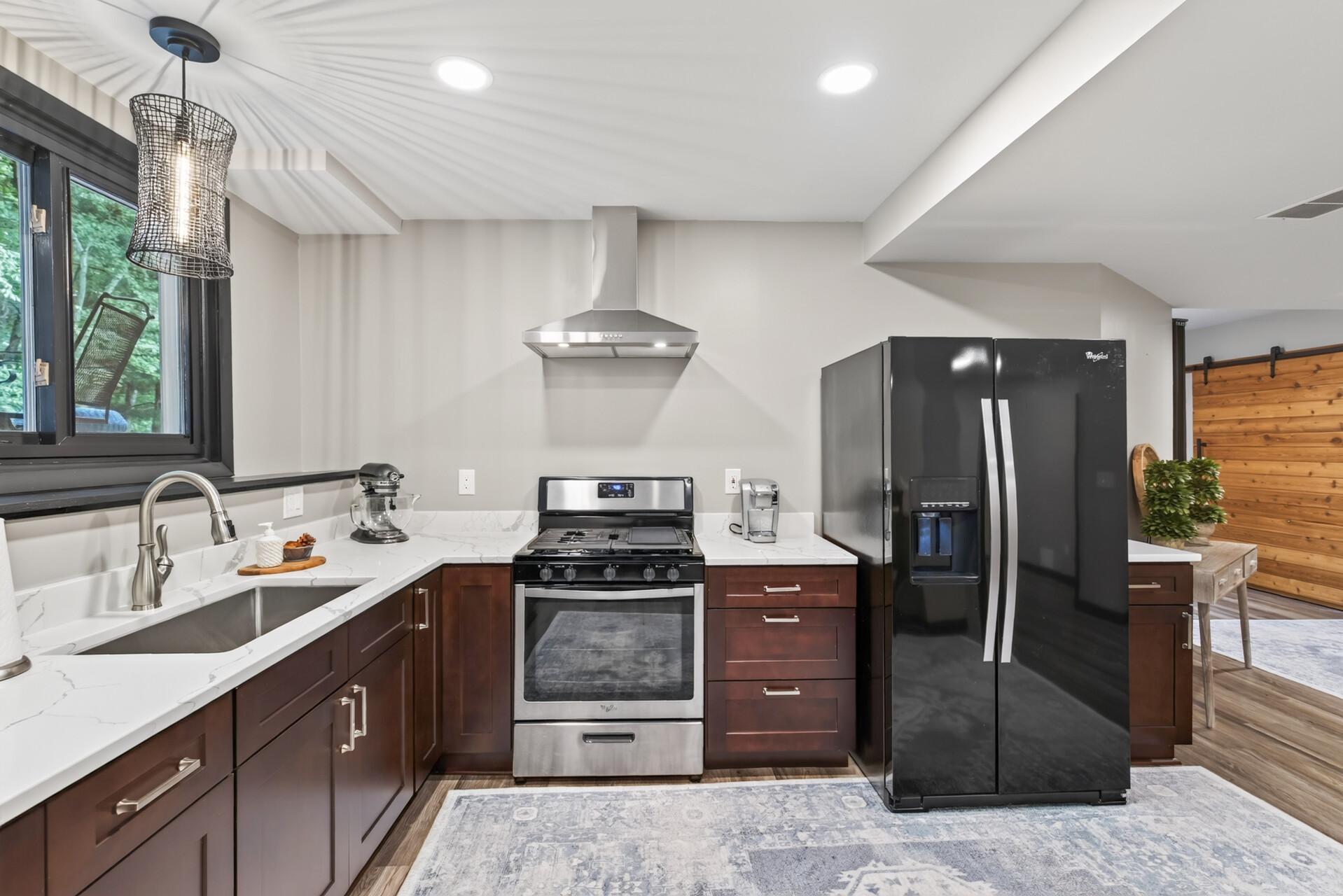 The beautifully finished lower level second kitchen adds flexibility for entertaining, hosting extended stays, or even multigenerational living.