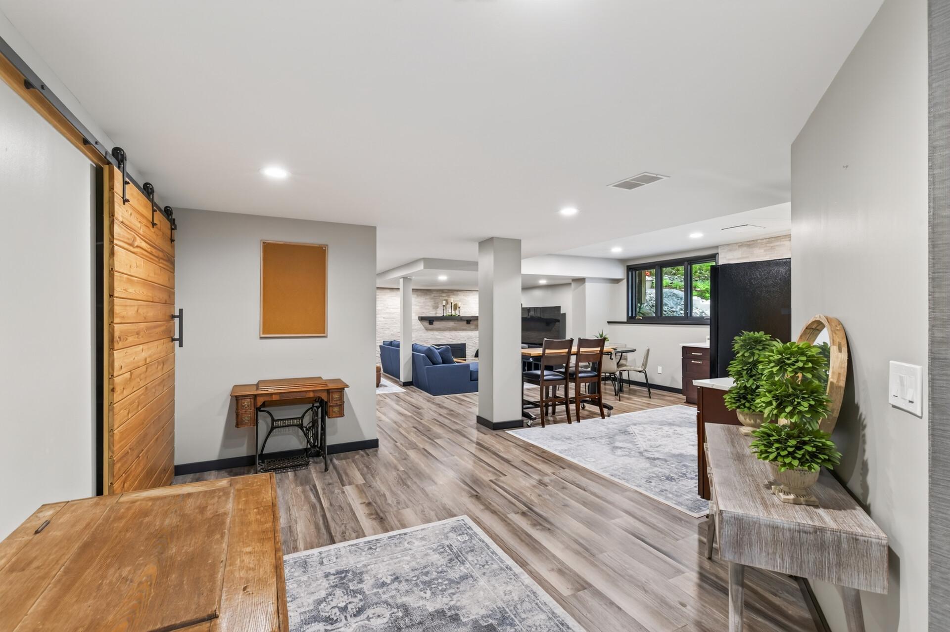 The open lower level connects the kitchen, dining, and recreation spaces for easy entertaining.