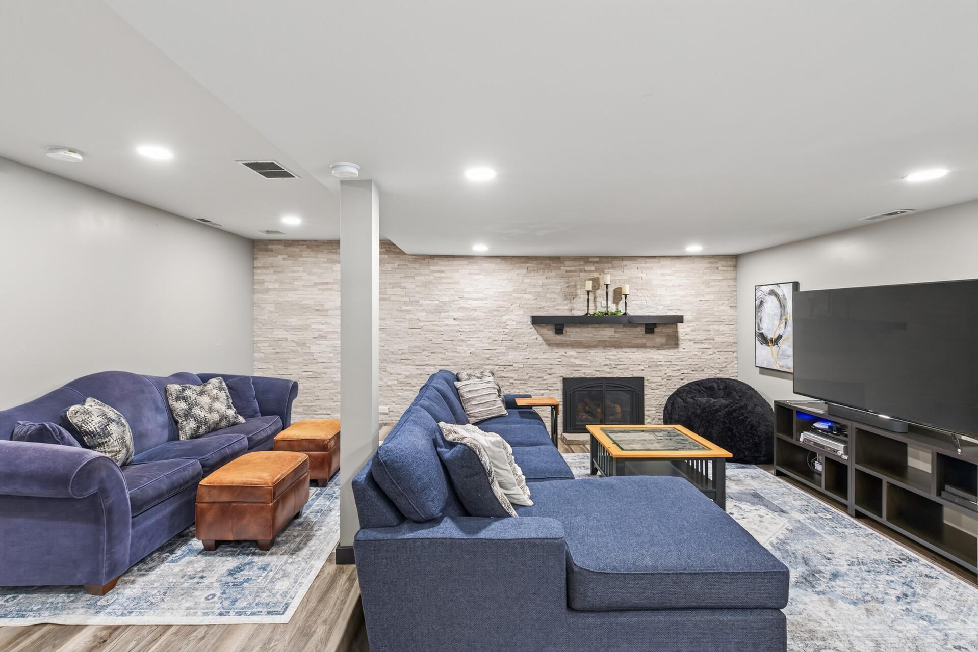 The spacious lower level family room creates a comfortable destination for movie nights, game days, and relaxed evenings at home.