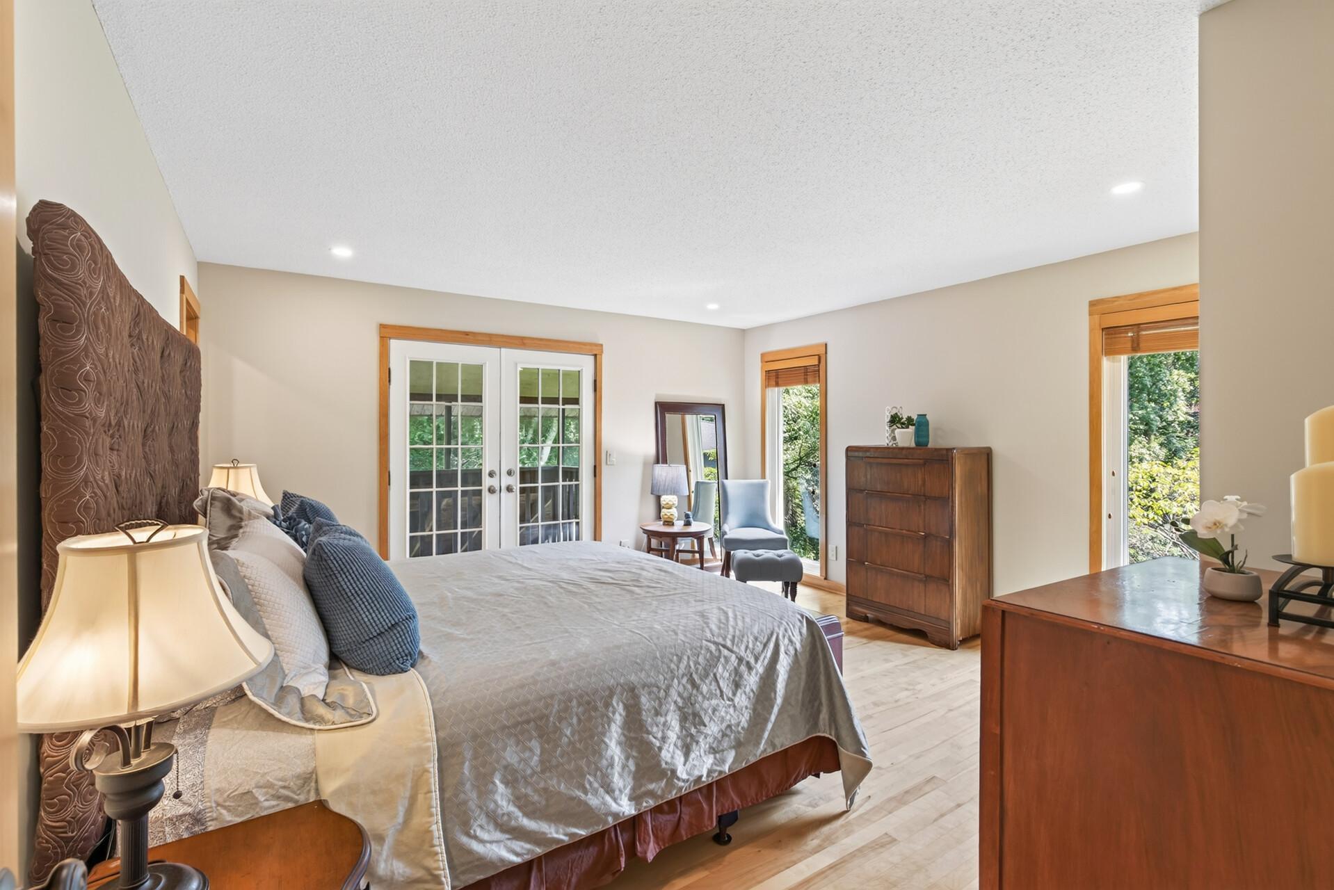 A second view of the primary bedroom highlights its generous size and access to the private balcony.