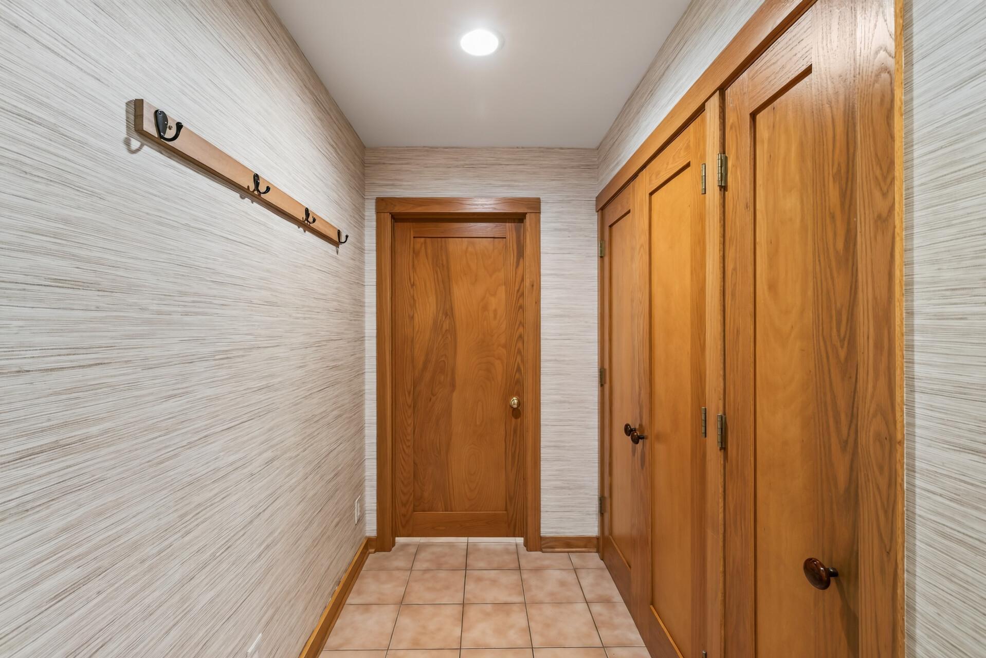 A large mudroom offers generous storage for coats, bags, and everyday essentials. This space walks into a large shoe room for even more convenient storage!