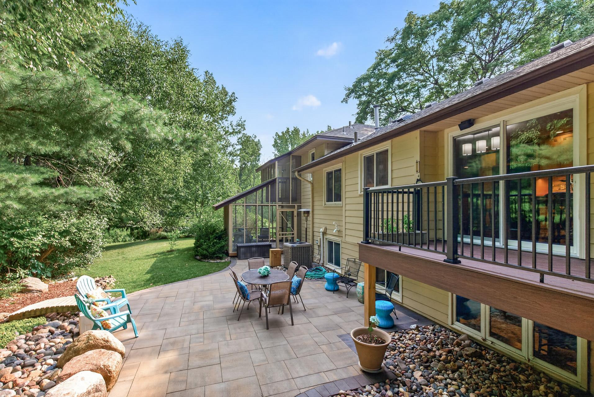 A private backyard oasis with multiple areas for relaxing, entertaining, and enjoying the wooded surroundings!