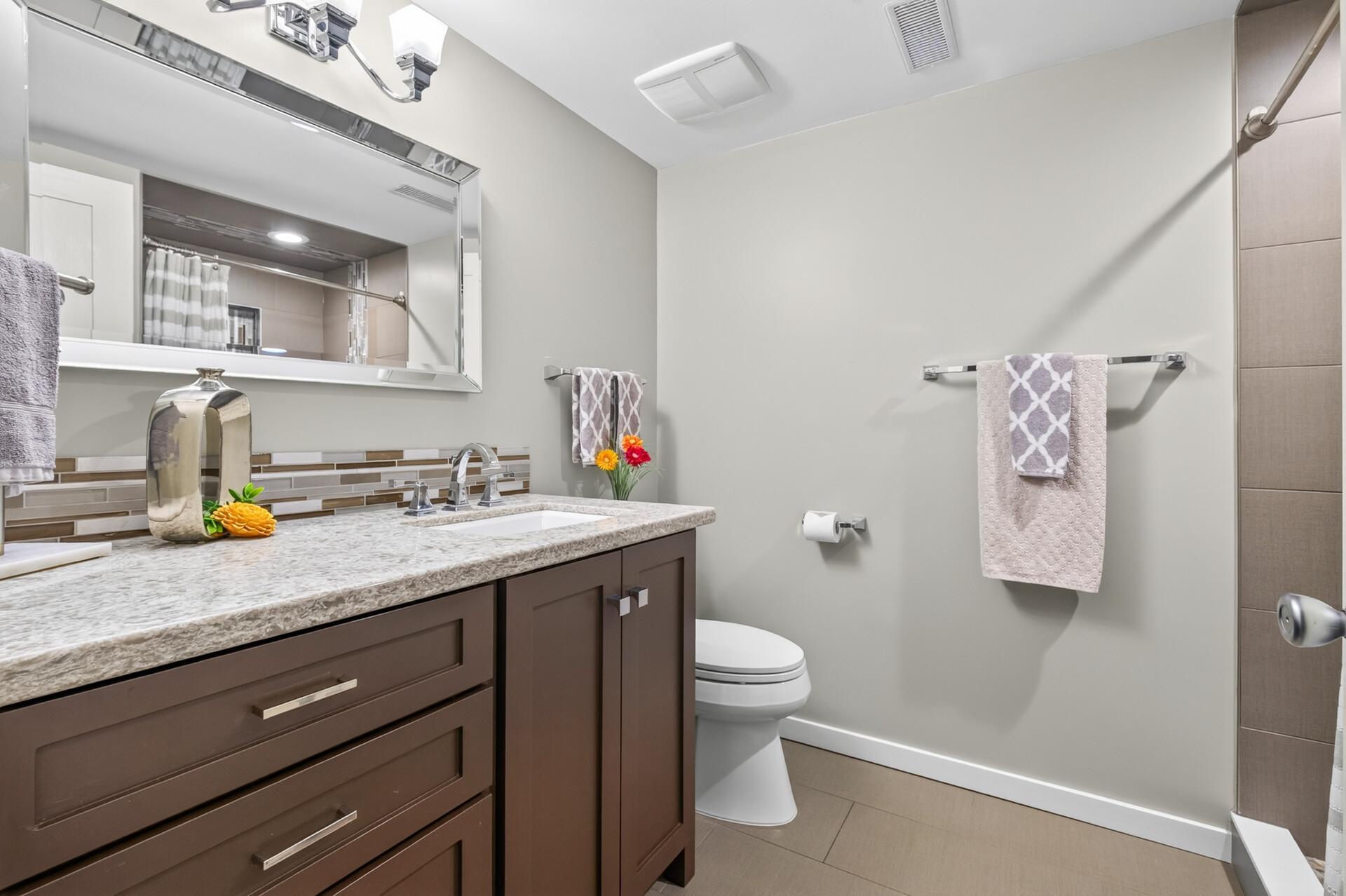 Beautifully updated bathroom on the third level of the home features a tile shower!