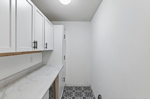 Extra storage pantry off entrance. New flooring, cabinets, & refrigerator!