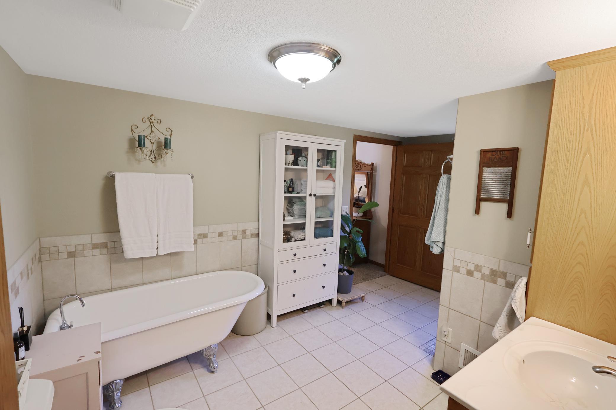 The main floor full bath offers a claw foot tub and walk-in shower.