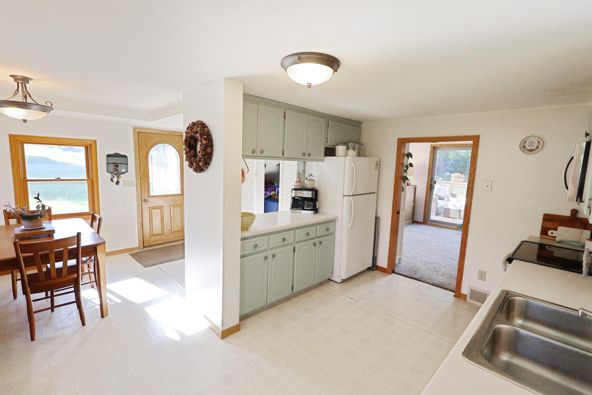 Kitchen view to the dining, rear entry, and the living room on the right.