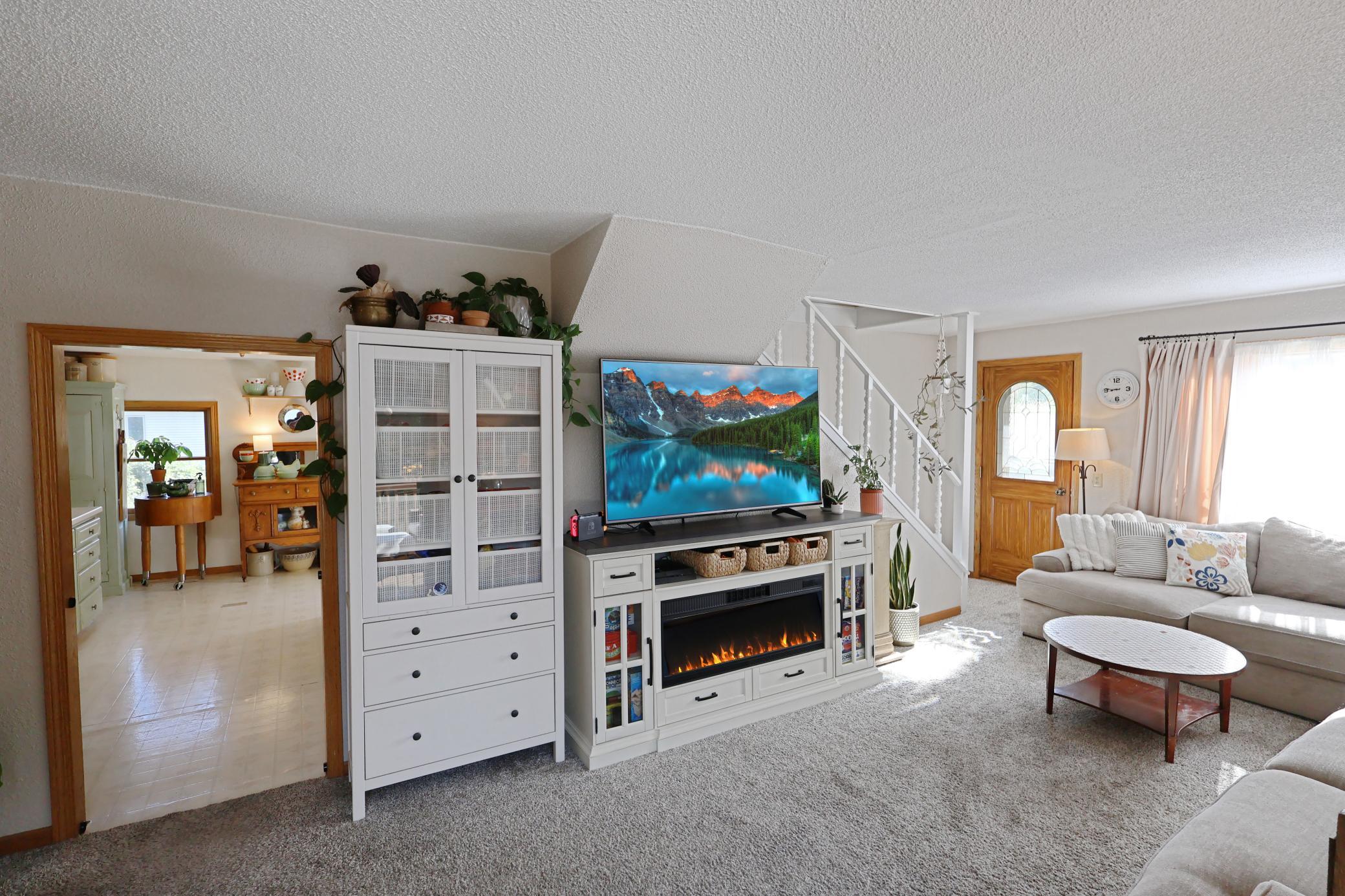 Bright and inviting living room and entry leading to the kitchen.