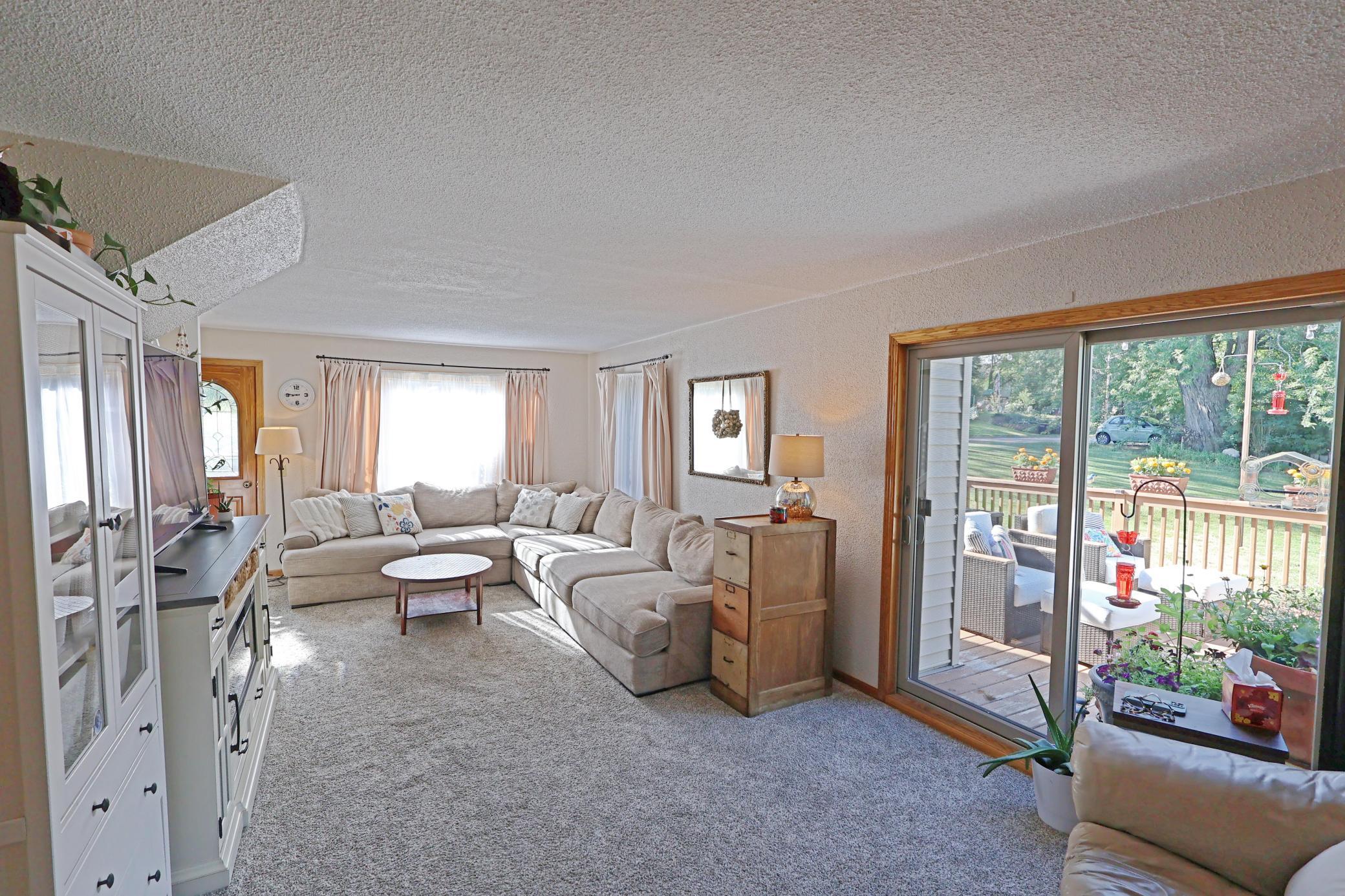 Tons of natural light fills the living room- that leads out to the deck area.