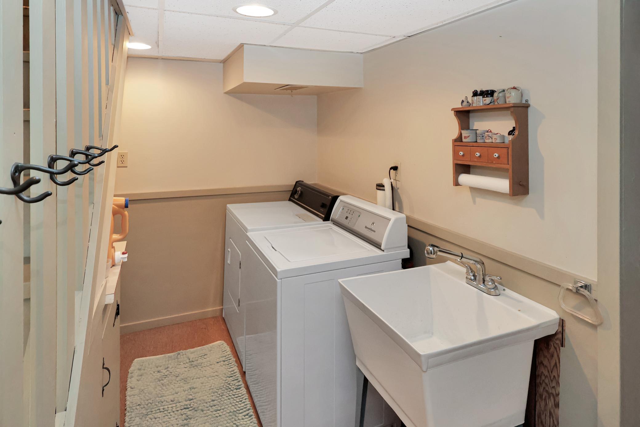 Lower level laundry area- washer and dryer to stay.