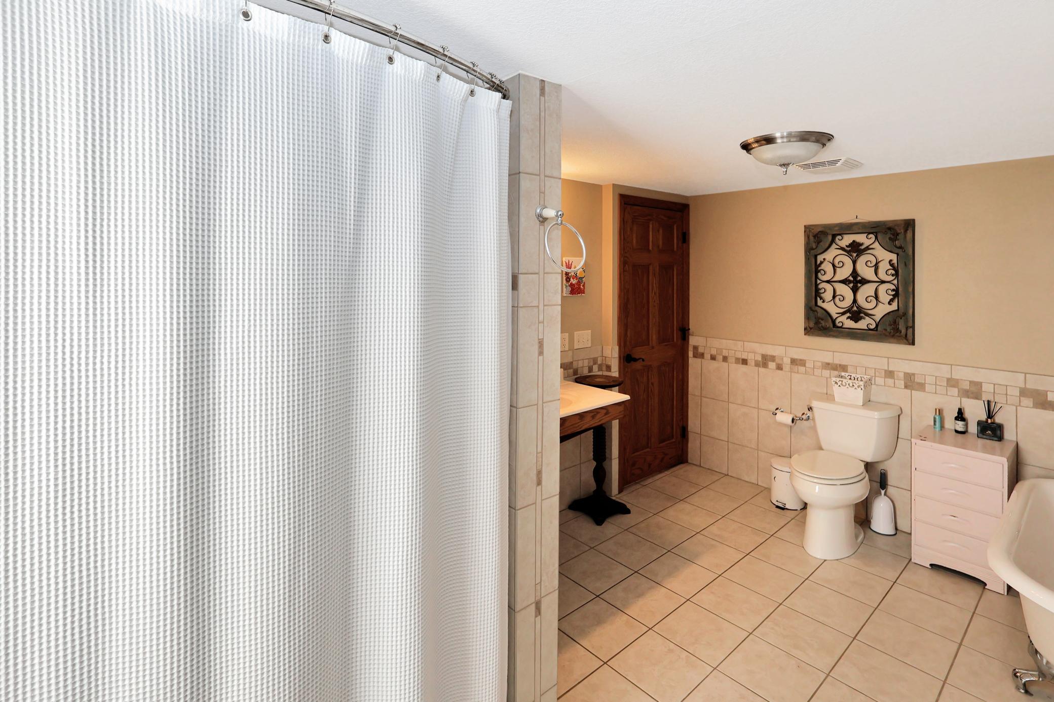 Main floor full bath with separate tub and shower.