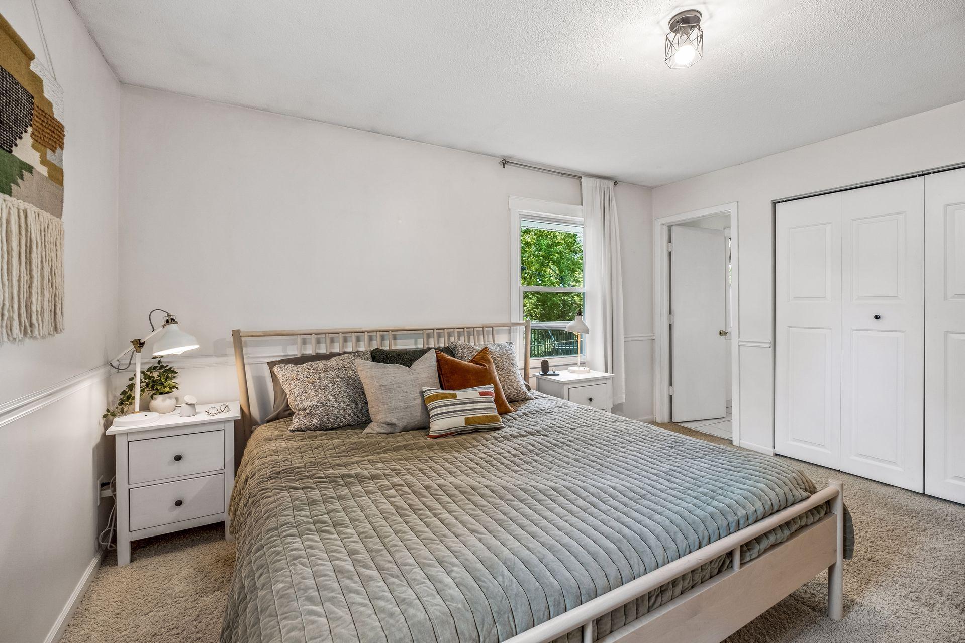 Primary bedroom with large closet and access to main floor bath