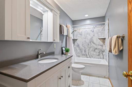 Very pretty primary bath has been recently updated with quartz countertops and finishes