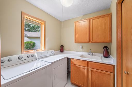 Main floor laundry with built ins/utility sink and is much larger that it looks