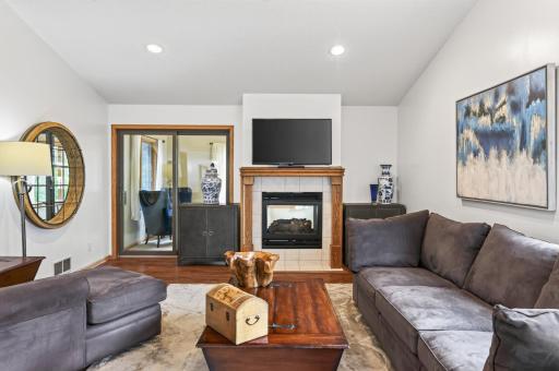 Two sided gas fireplace and sunroom on the other side