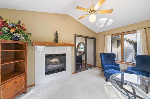 Two sided fireplace anchors the sunroom and living room