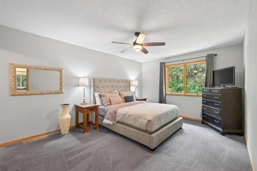 Ample sized primary bedroom overlooks your private yard