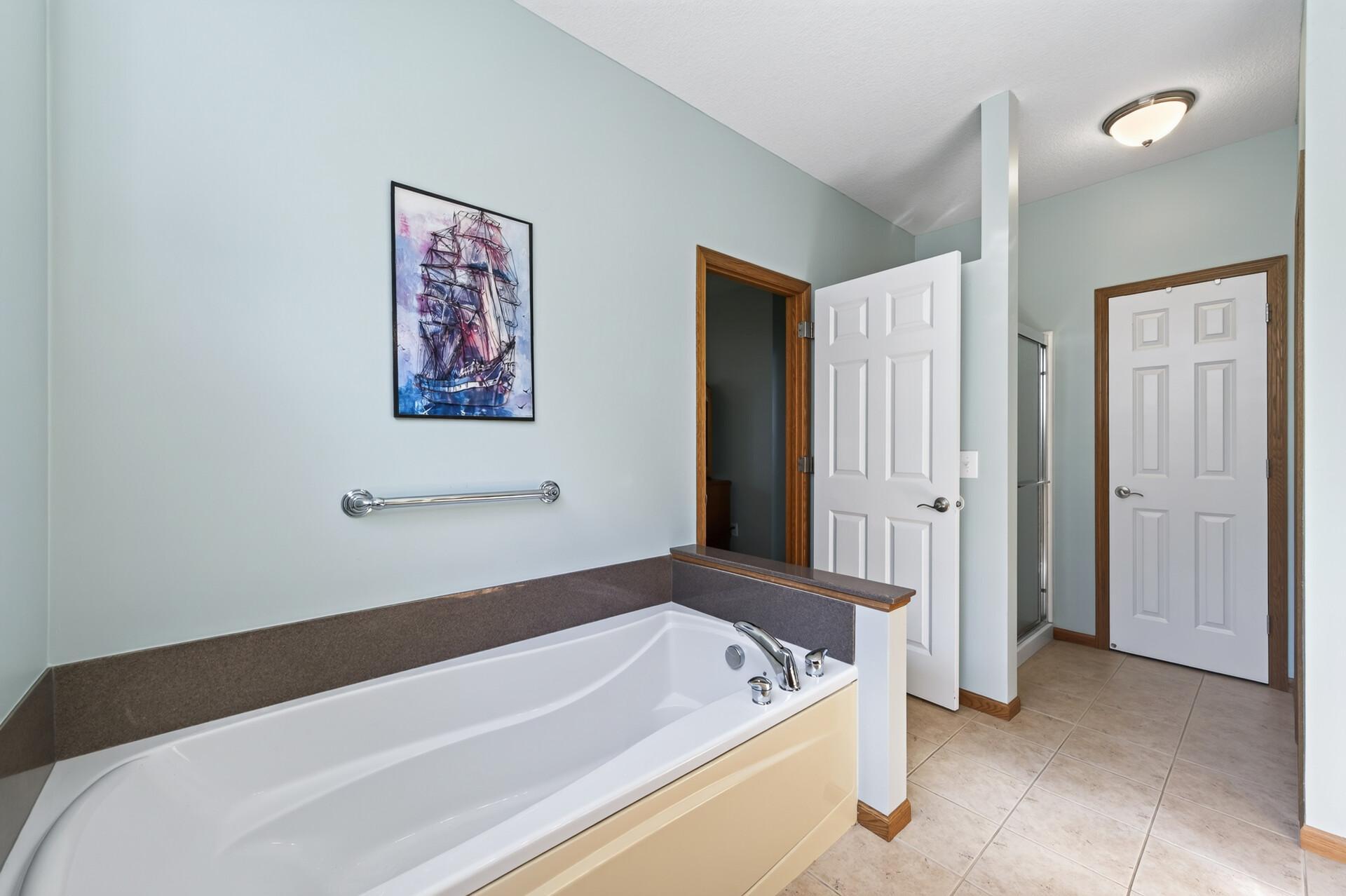 Relax at the end of the day in this soaking tub! Full walk-in closet with shelving.