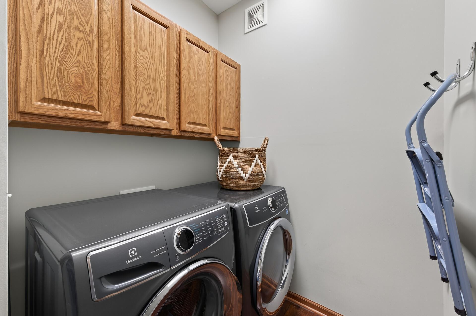Laundry room is complete with upper level cabinets. Washer and Dryer Hook up.