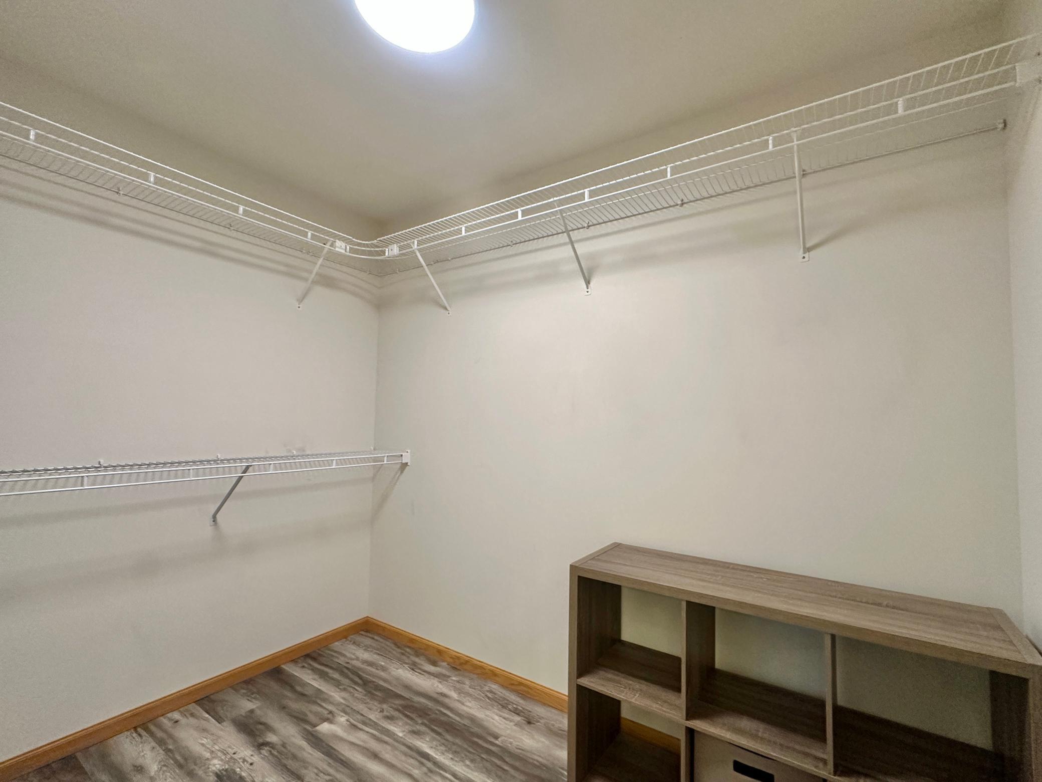 This walk in closet has a ton of room for most of your extras.