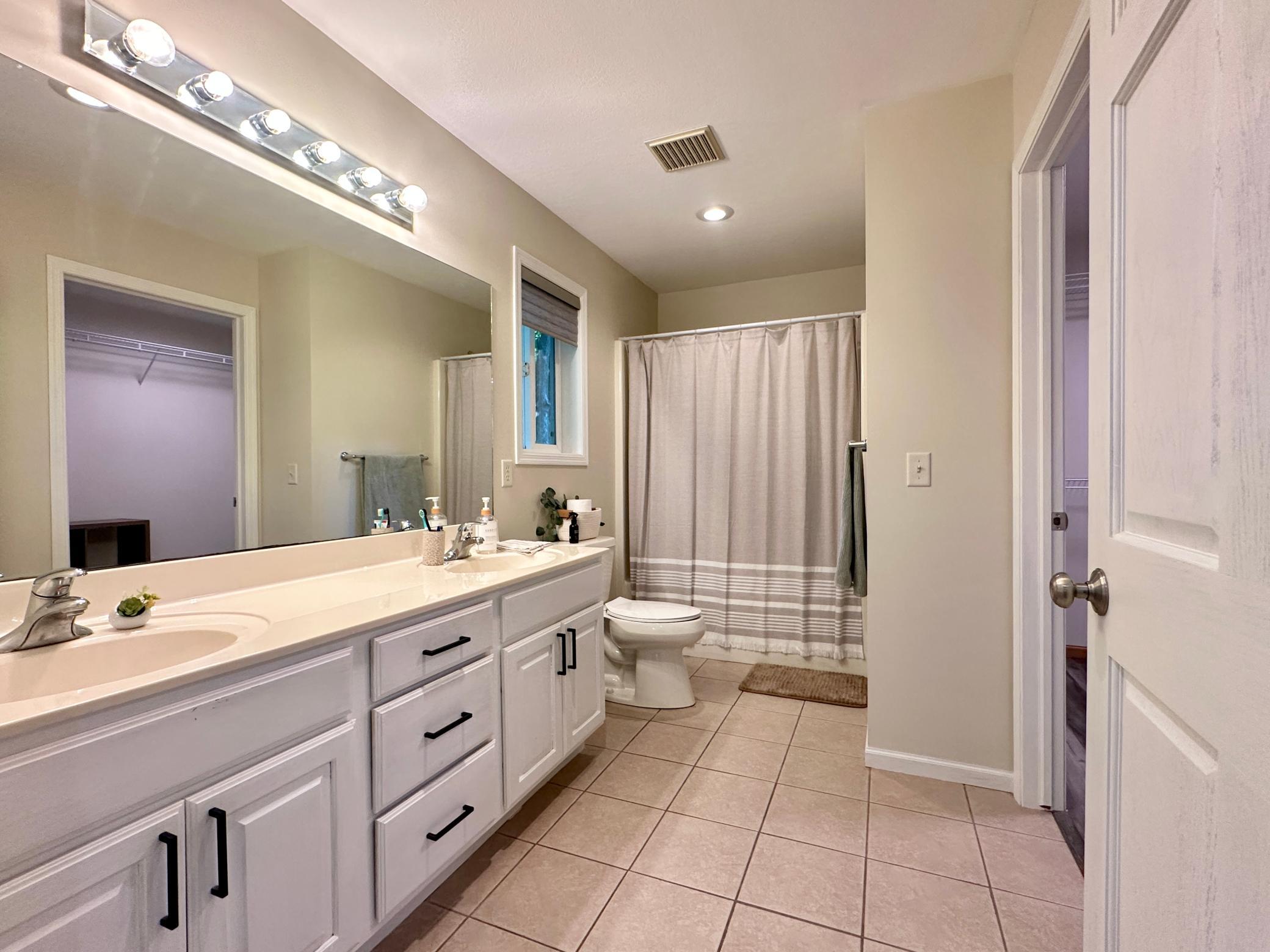 The owners suite has tile floors as well along with double sinks and hard surface counter top.