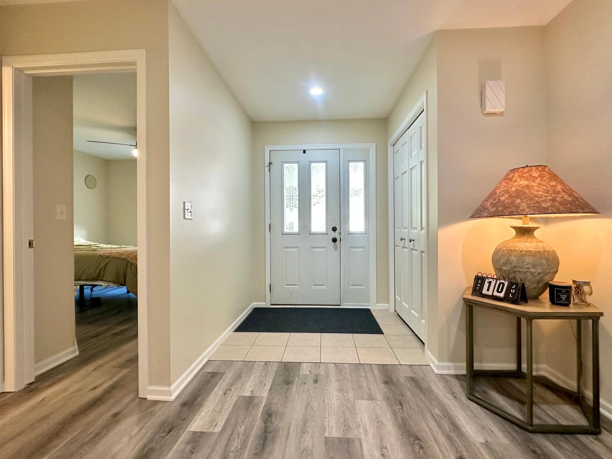 This view of the entry reveals the one of the two bedrooms with a guest bath next to it.
