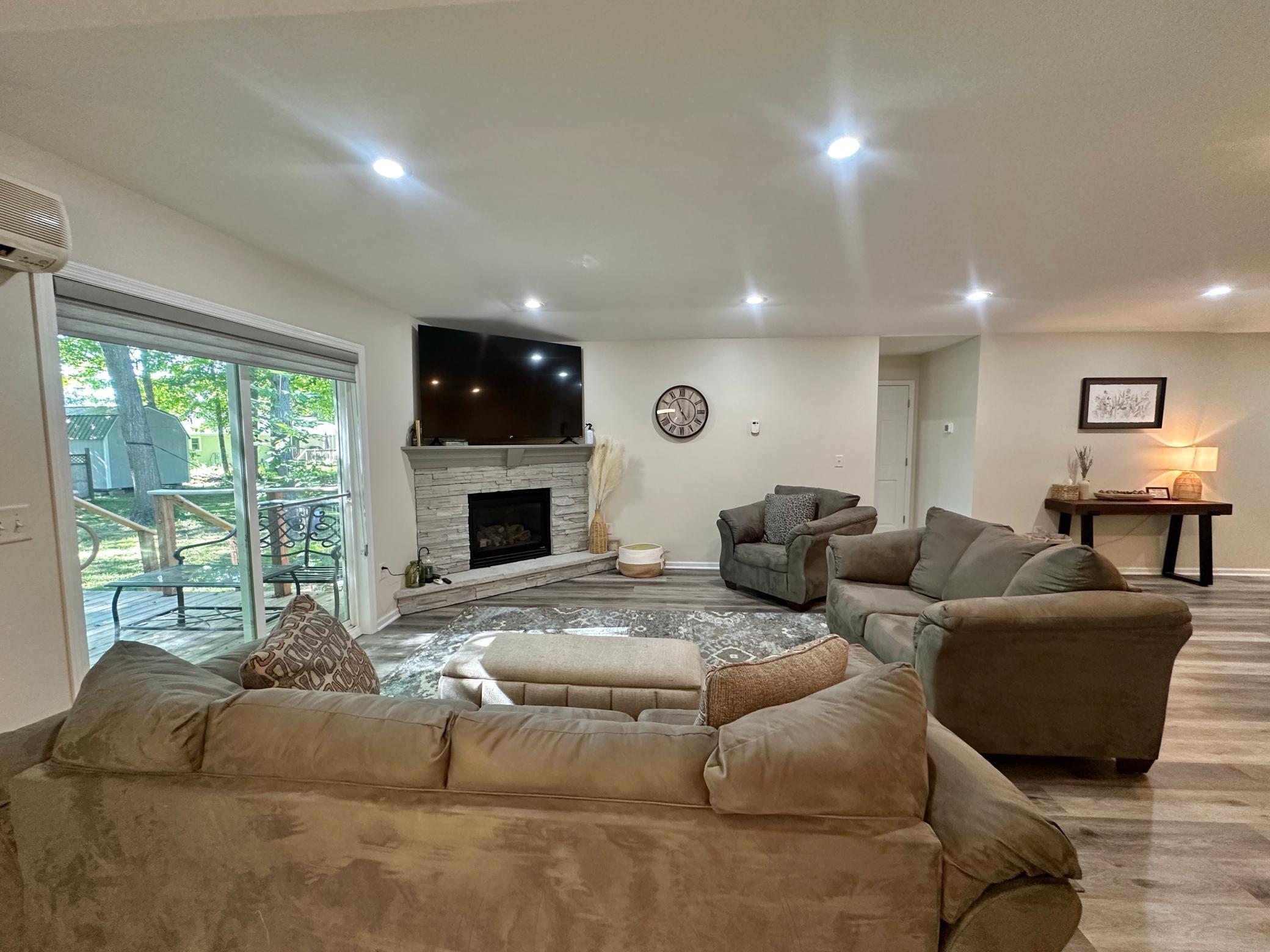 A look over the cozy living room with the stylish gas fireplace and the LVP flooring through out the home.