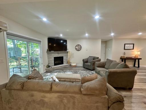A look over the cozy living room with the stylish gas fireplace and the LVP flooring through out the home.