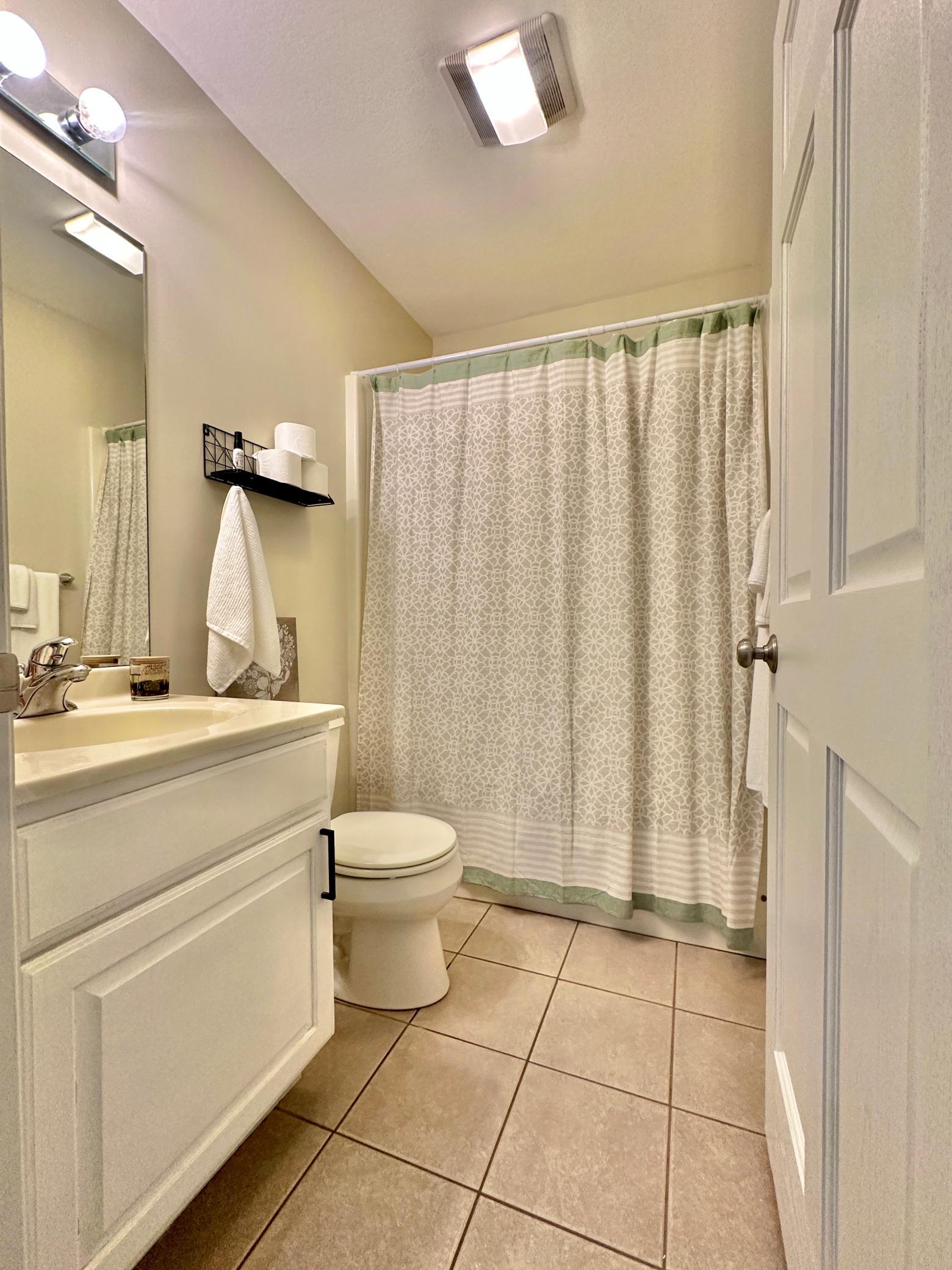 Tile floors, white cabinets and hard surface counter.