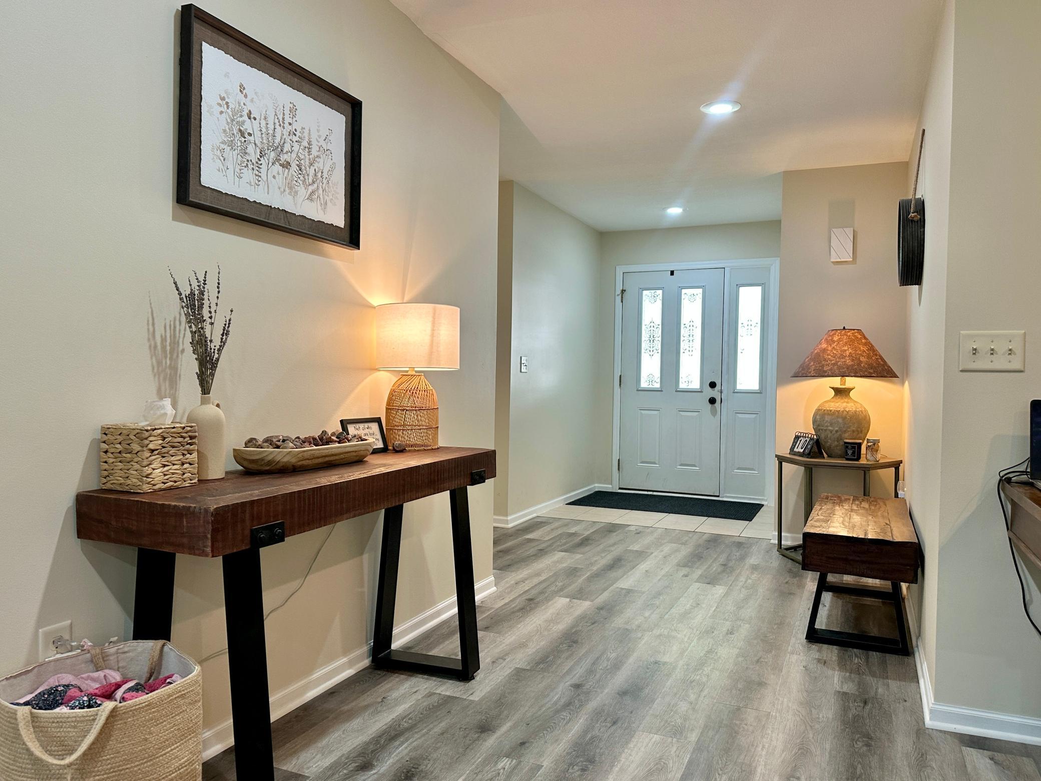 A view of the spacious entry and the tasteful decorating, it looks like a model.