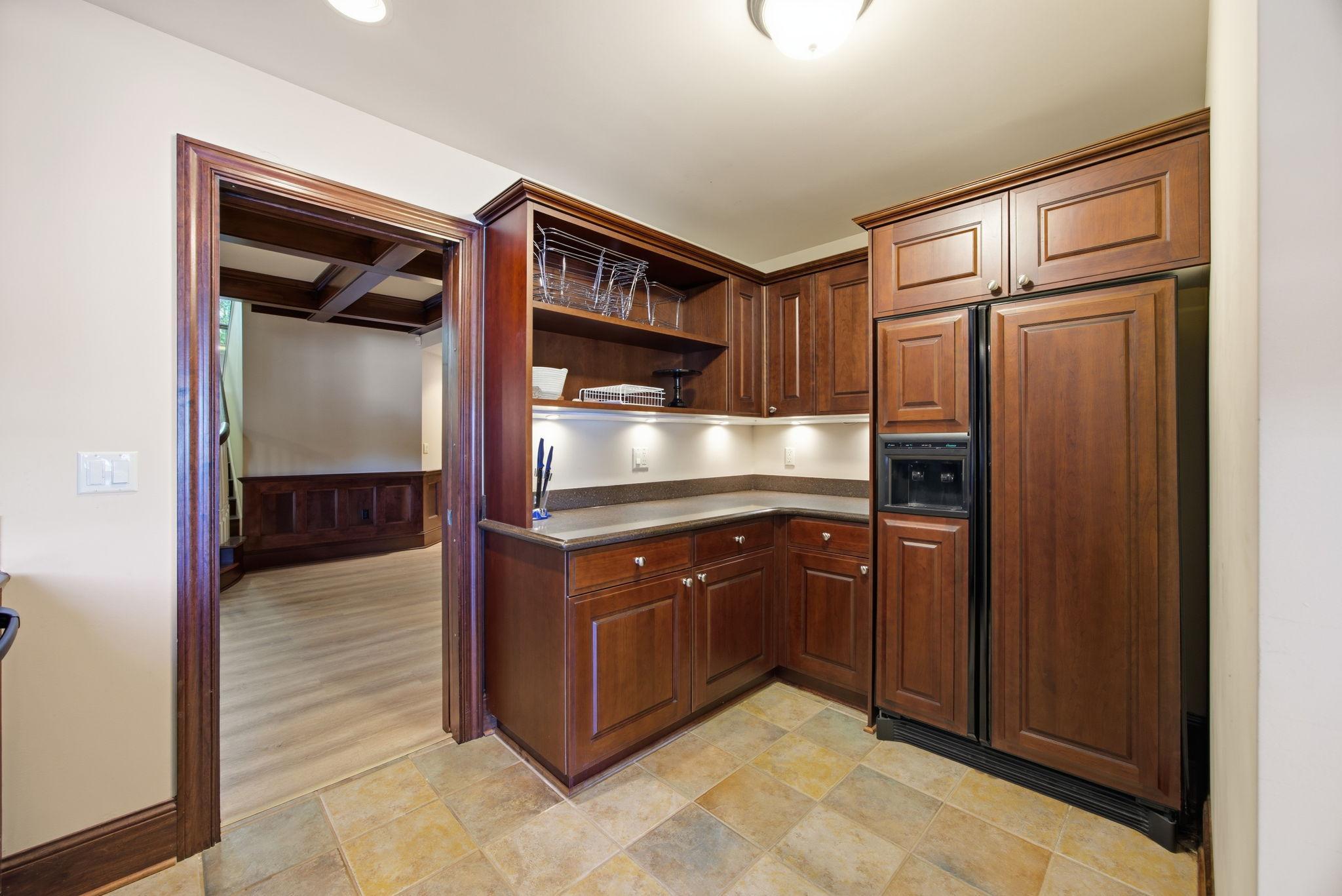 A chic second kitchen and wet bar keep refreshments close to the home's recreation spaces