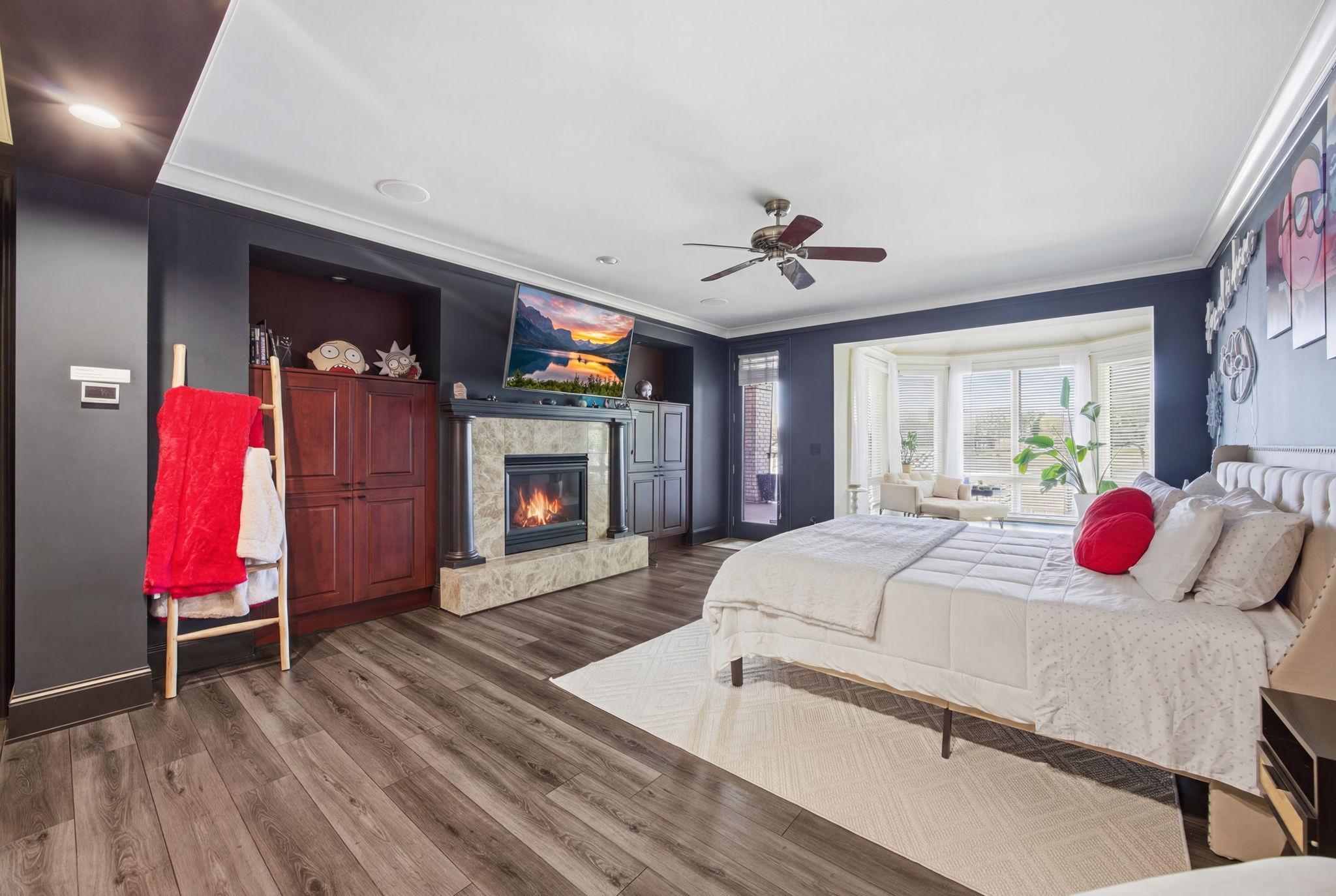 Escape to the luxurious main-level primary bedroom featuring a private sitting room with lake views, a spacious walk-in closet, and a spa-inspired ensuite bath