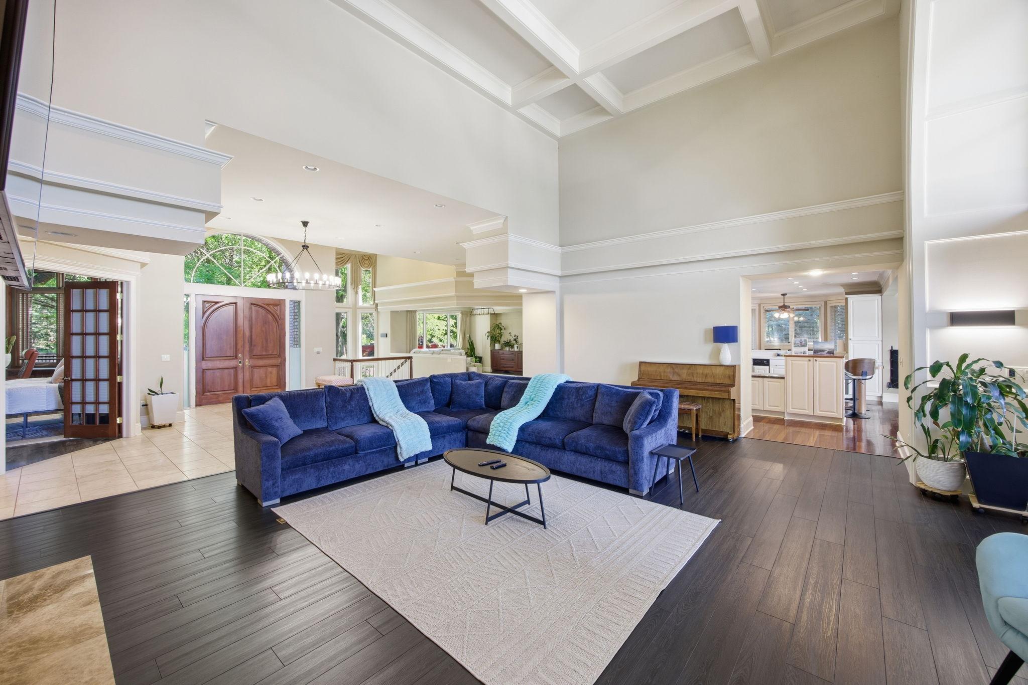 Open concept living with rich wood and sleek tile floors throughout