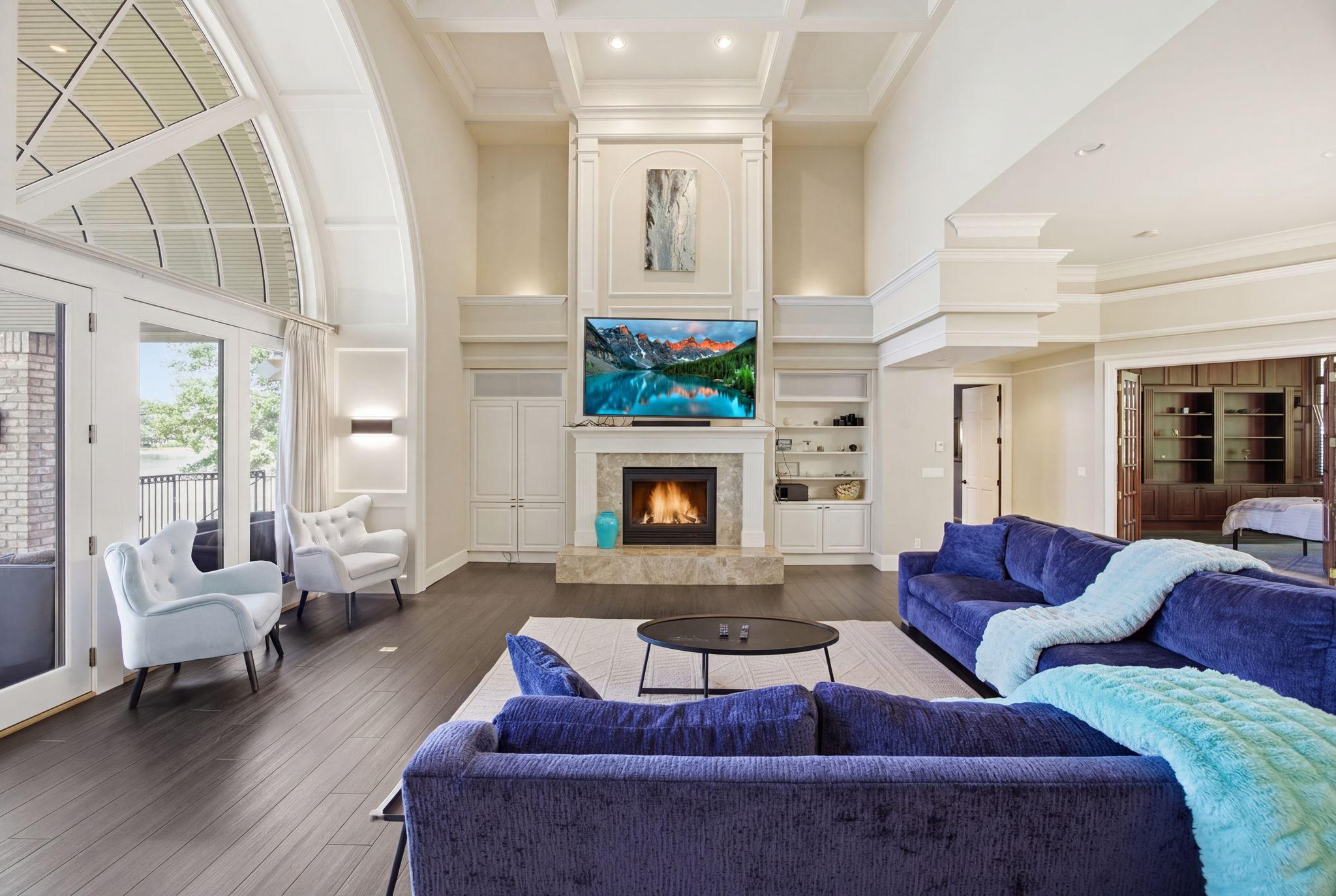 The vaulted living space is highlighted by a stunning fireplace and custom built-ins, creating a warm and inviting focal point