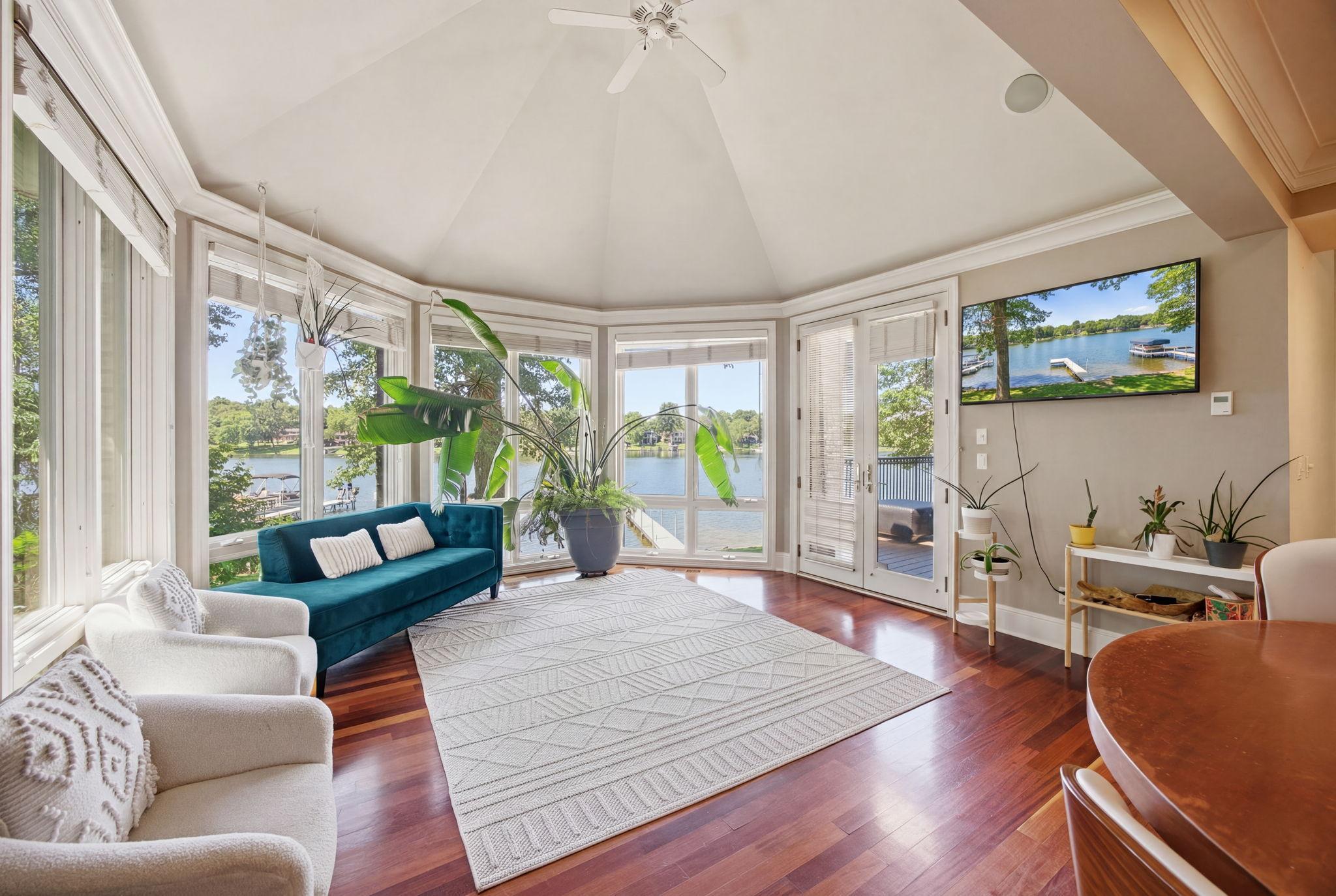 The bright and airy sunroom extends the living space with stunning views and direct access to the deck