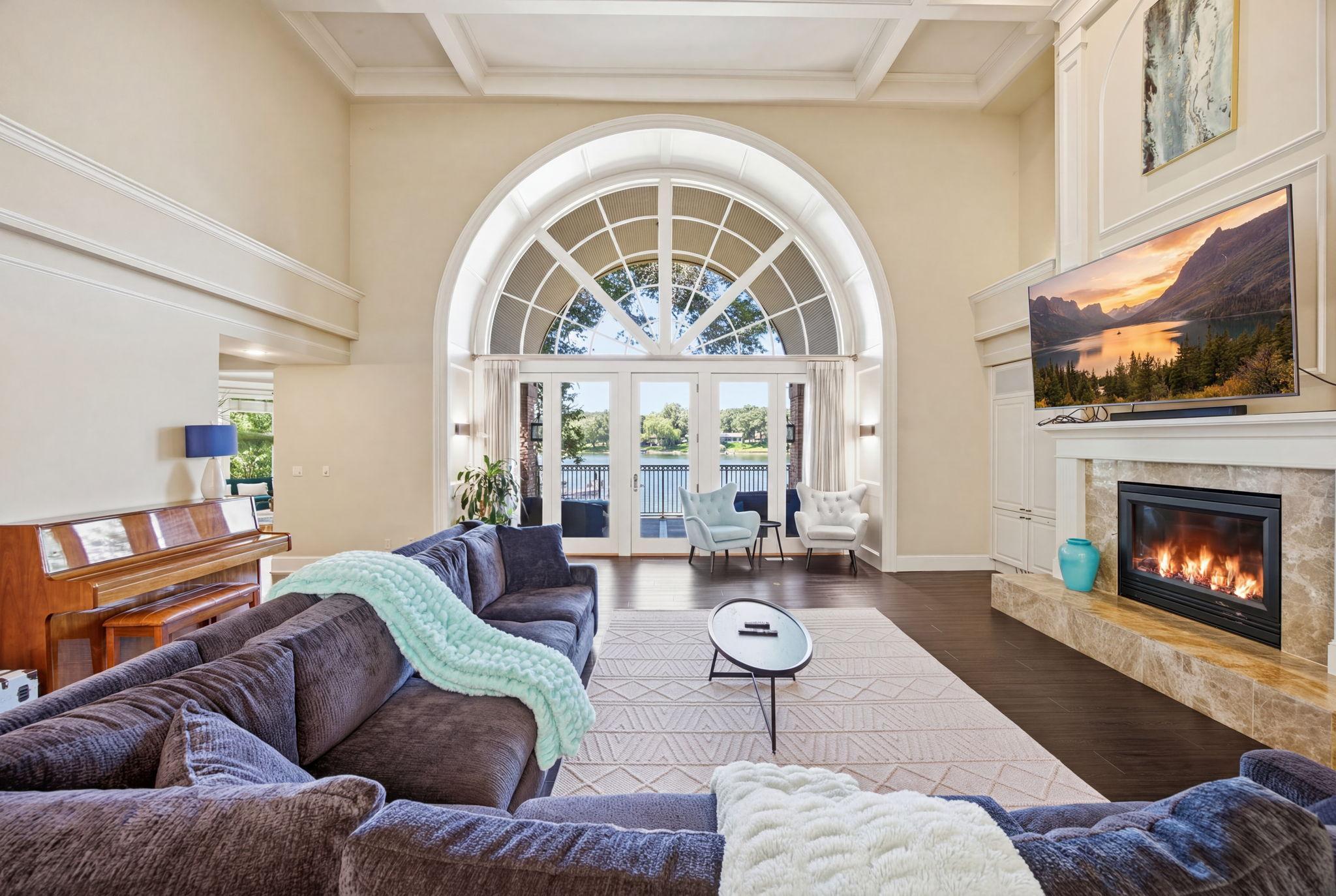 Gather around the fireplace in a beautifully proportioned living space filled with natural light