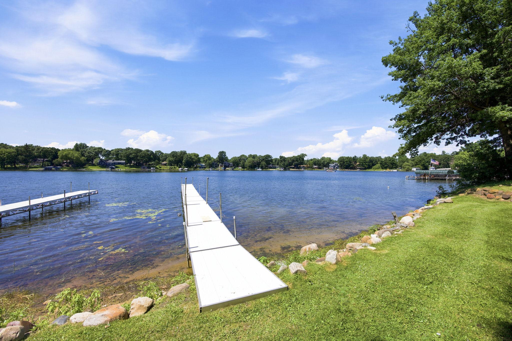 The dock extends into sparkling blue water, offering a front-row seat to lake living
