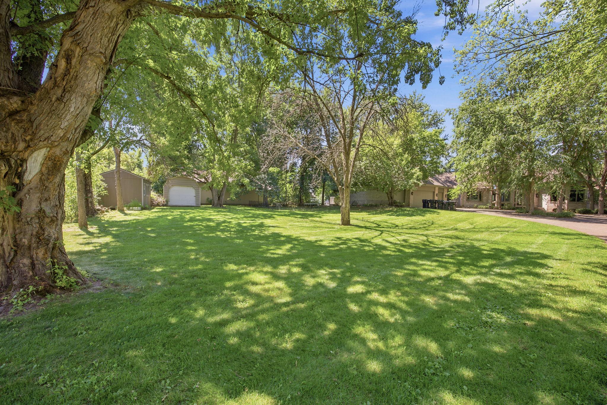 Lush lawn and mature tree coverage offers a private setting throughout the property